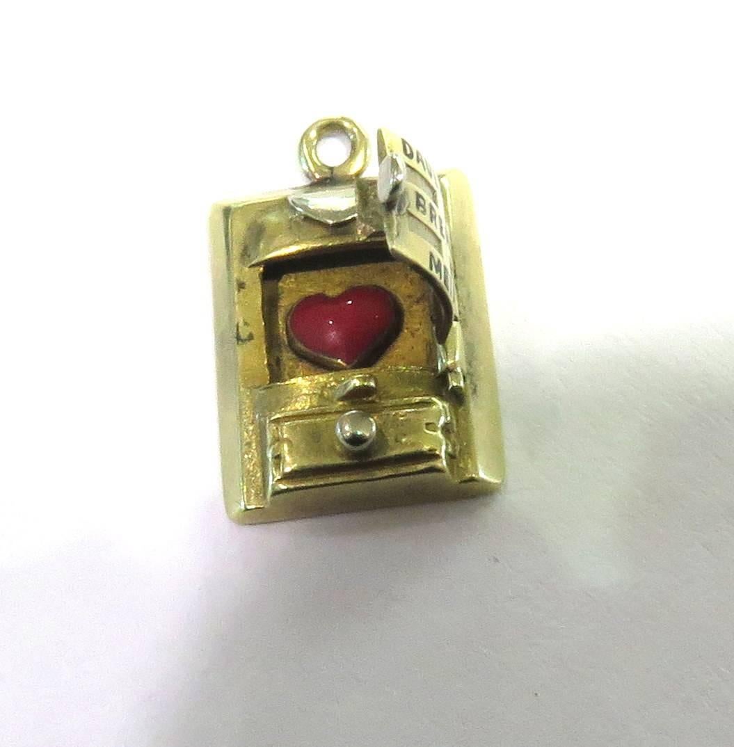 This incredible amazingly detailed 14k gold wood stove charm when closed, is written Dauernd Brennt Mein. When opened shows a red enamel heart. This charm translates from German, with enamel heart, to read: My Heart Is Constantly Burning