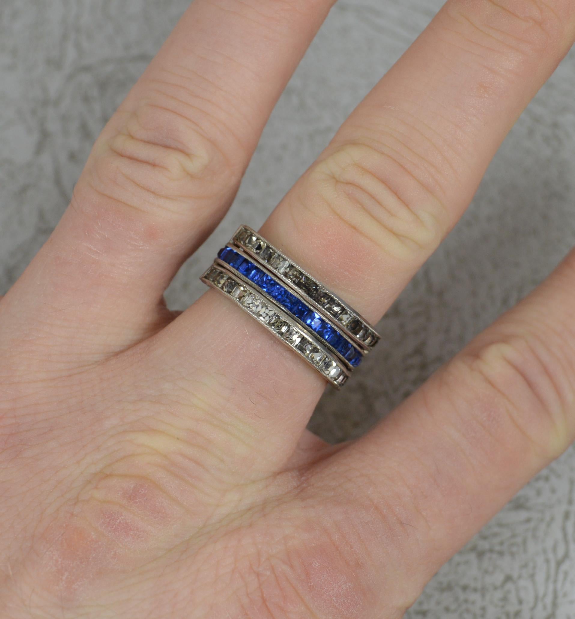 A fine art deco era ring, circa 1920.
Sterling silver example.
A full eternity example, day and night design. Half set with princess cut blue paste and the other princess cut red paste. Then complete with two hinged sections of princess cut white