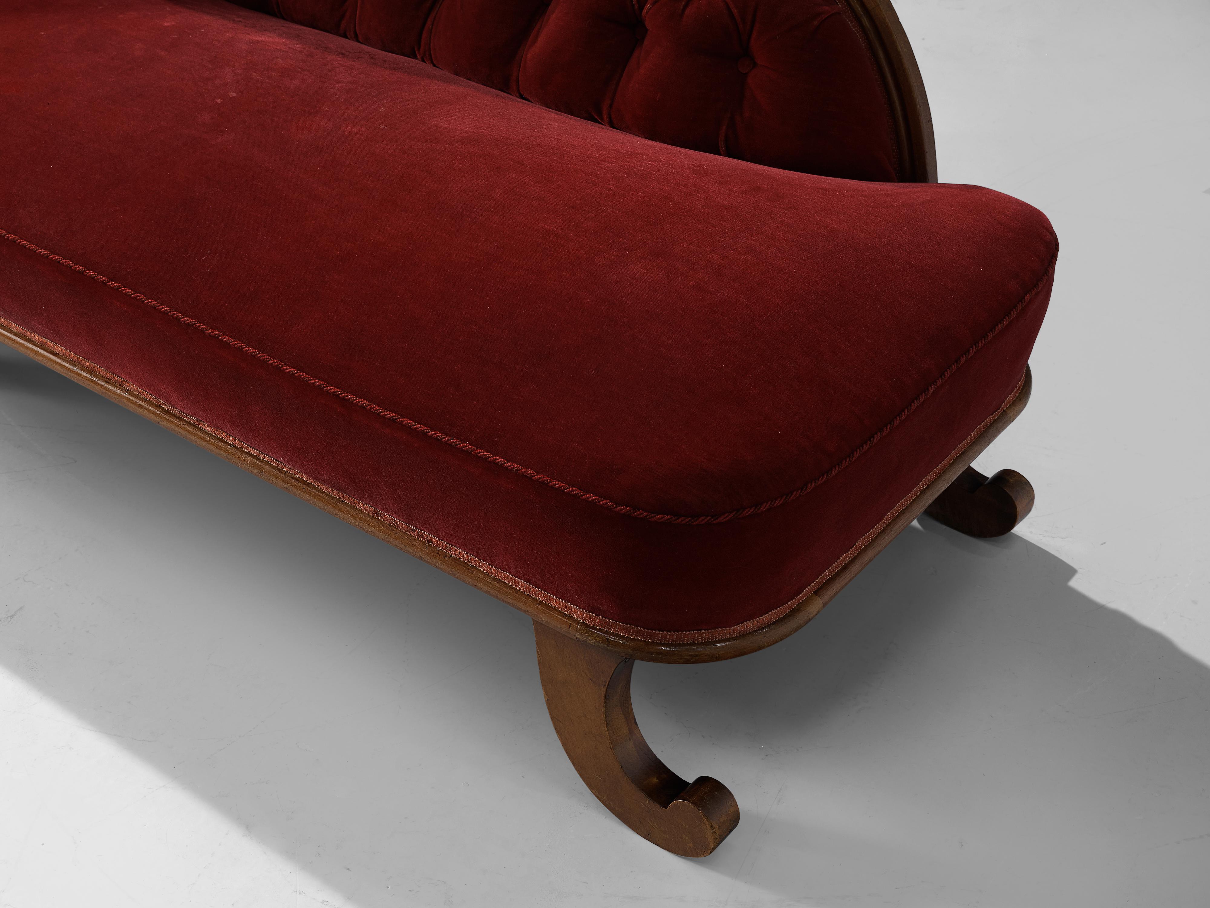 Daybed, velvet, walnut, France, 1930s

Very elegant art deco daybed in red velvet. The frame of the daybed is executed in walnut and shows stunning ornamental decorations. This is especially visible in the legs which are curled upwards, adding to