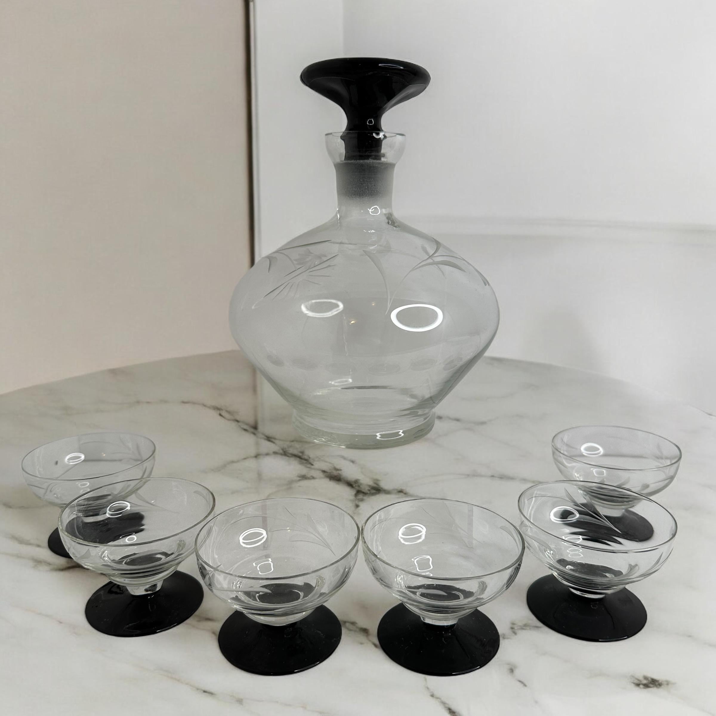 A slightly cheeky Art Deco decanter set with matching set of six glasses in handblown clear glass, in the style of Bimini. The stems designed minimalistic with black glass. In beautiful clear and black colors. Very delicate to touch and amazing that
