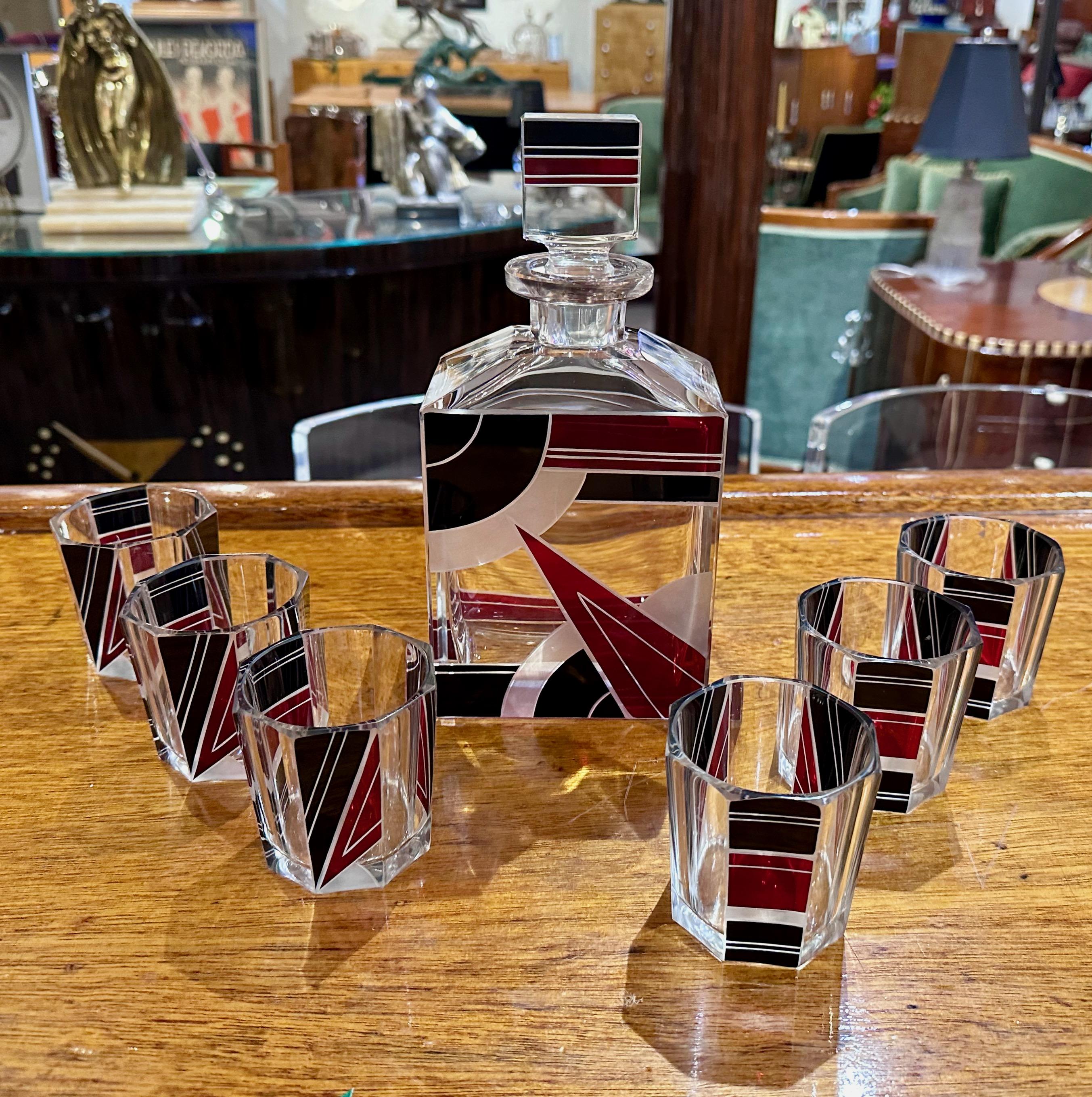 A stylized Czech Decanter Set with deep red and black designs – the work of innovative and forward-thinking artist Karl Palda.  The glasses are an especially nice size- not the tiny shot glasses that often accompany decanter sets of this type, but a