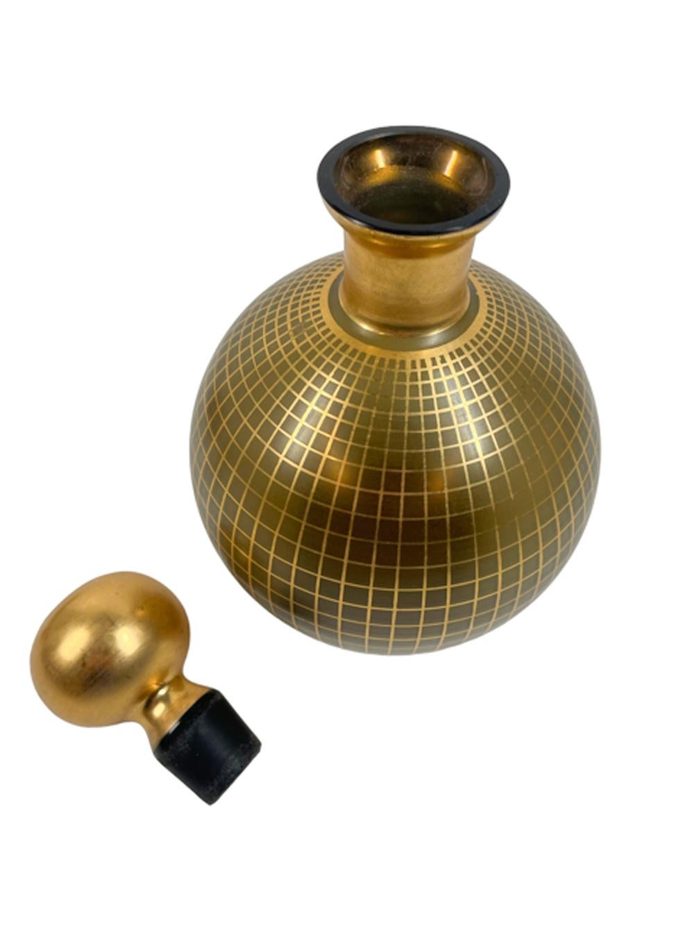 Art Deco decanter set - spherical decanter and six snifter shaped glasses in pale brown amber glass with a gold grid decoration on the decanter body and bowls of the glasses, the decanter neck, stopper and foot of the glasses are completely gilded.