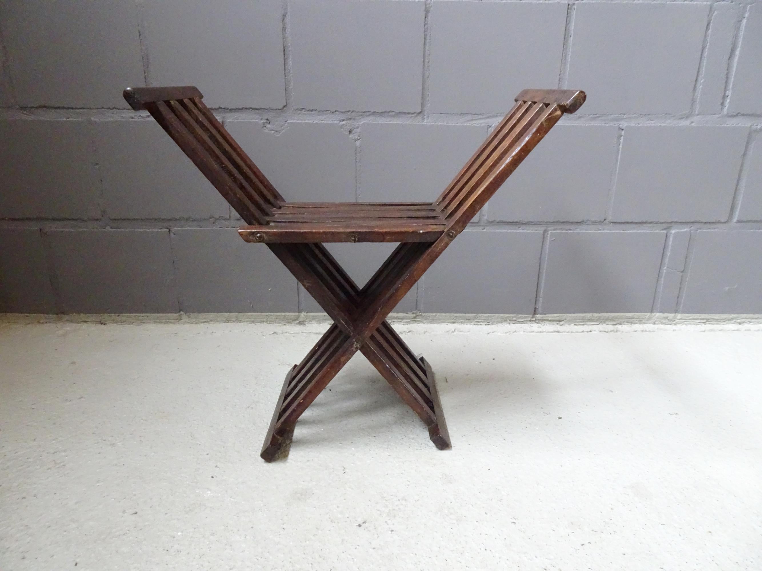 Antique wooden stool with folding function made of beechwood. A rare piece that immediately impresses with its function and appearance. The scissor chair can serve as a stool, but also very well as a side table or console.

It is folded in just a