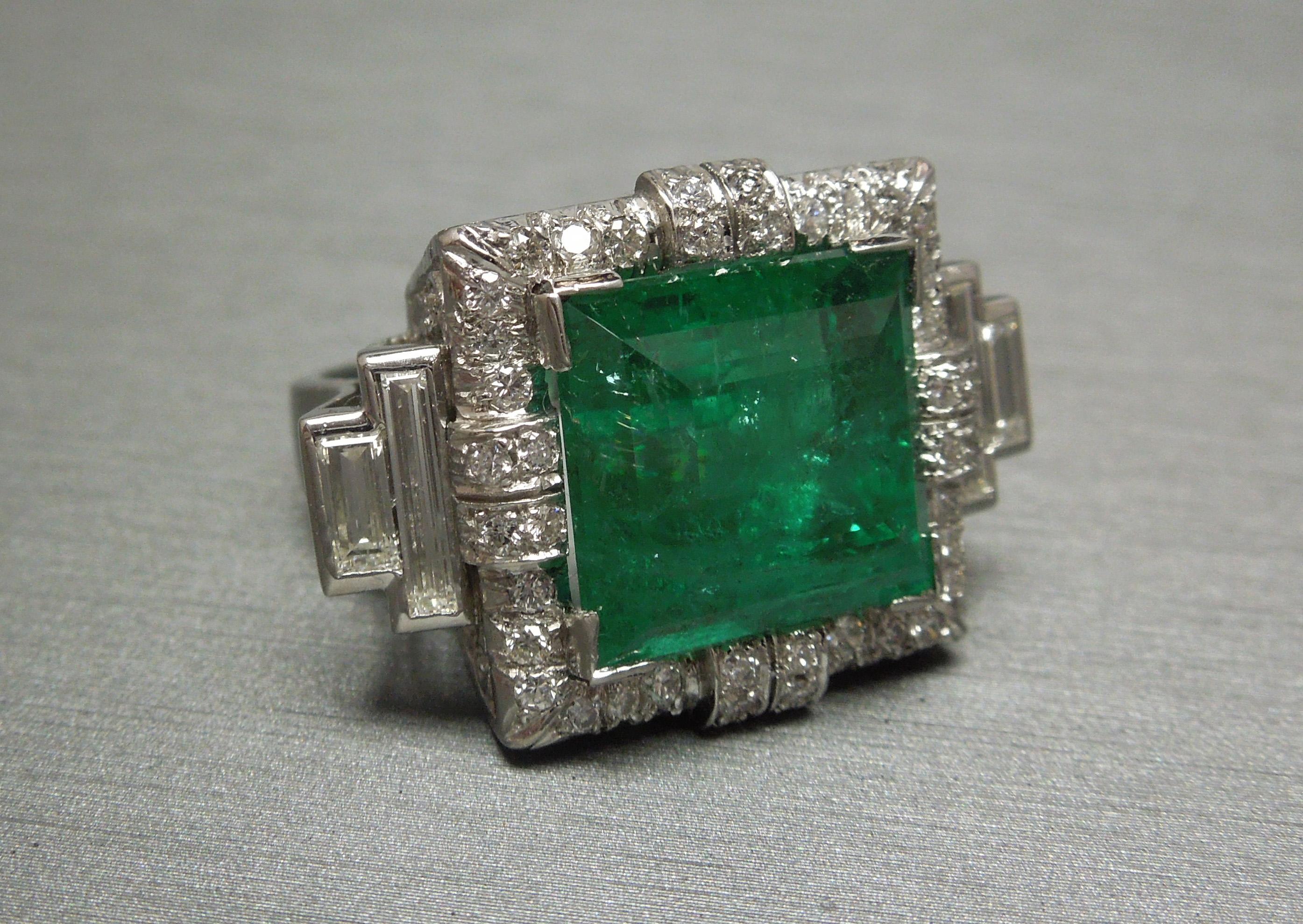 An unparalleled reflection of the Art Deco era, this GIA Certified Colombian Emerald ring possesses every desirable trait of an Art Deco period piece. A central museum / vault quality 12.75 carat vivid green Emerald, well balanced with a total of