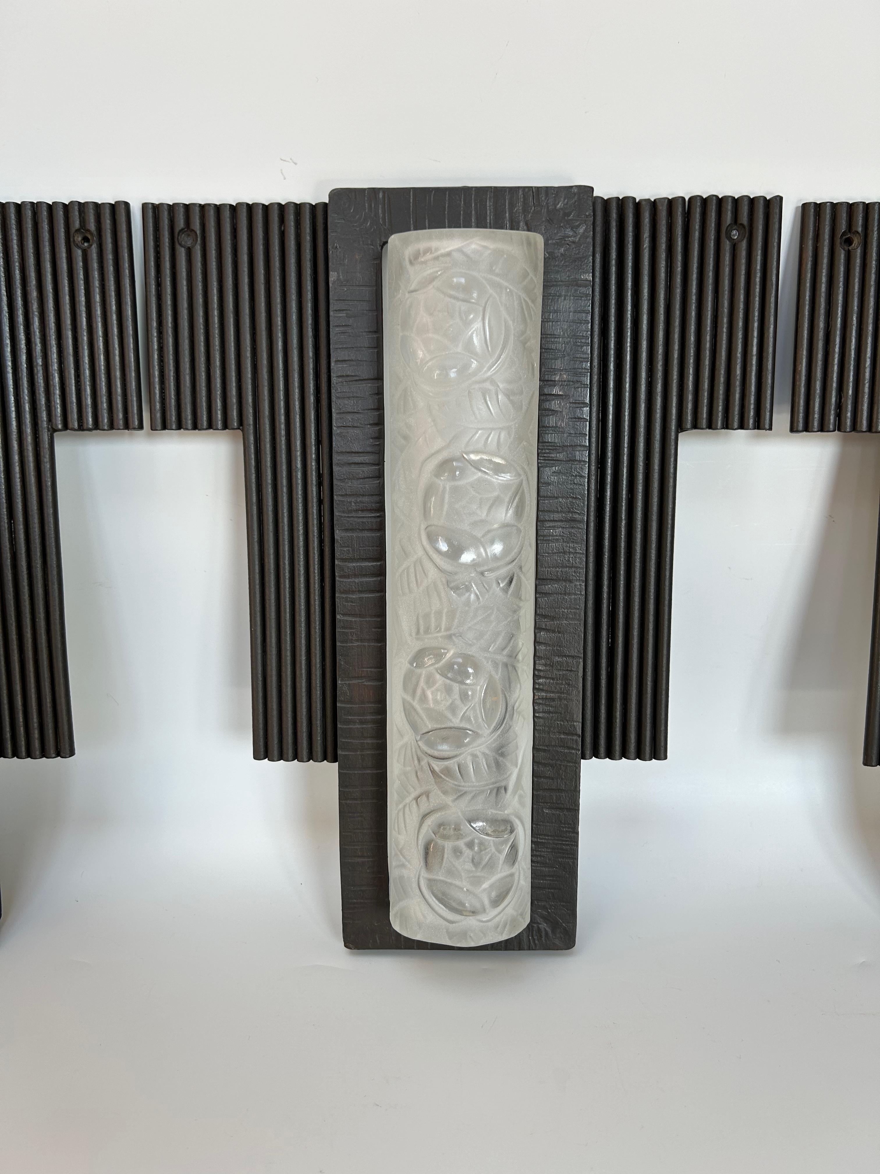 Suite von 3 Art-Deco-Wandleuchten Modell 501 von Degué, verziert mit Rosen und Blättern. 
Rahmen aus Schmiedeeisen
Elektrifiziert und in perfektem Zustand.

Breite: 25,2 cm
Höhe: 31,5 cm
Tiefe: 6,5 cm
Gewicht: 7,3 kg (2,4 kg x 3)

DEGUE (David