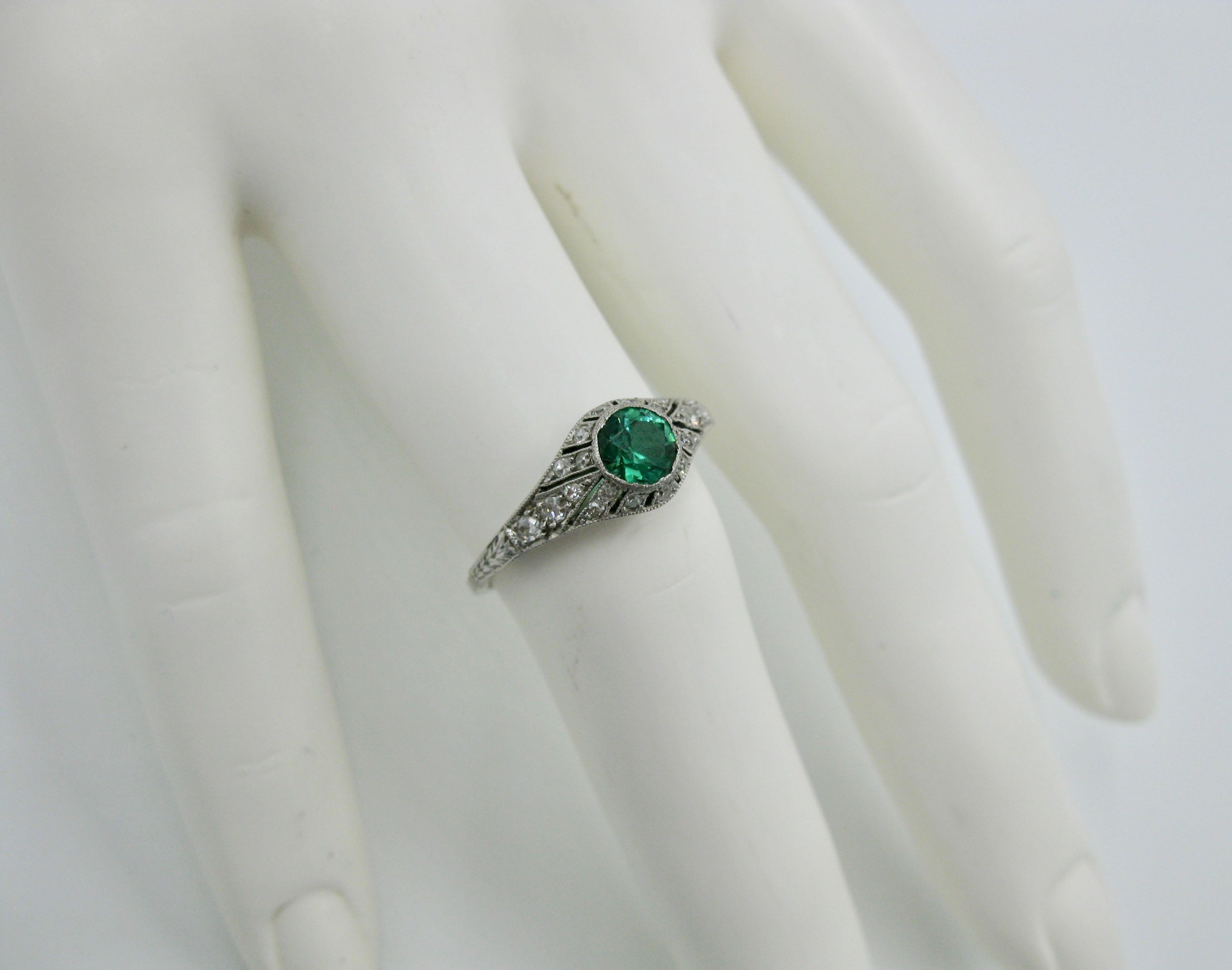 A stunning Antique Art Deco .4 Carat Green Demantoid Garnet Diamond Platinum Wedding Engagement Ring.  The central round faceted Green Garnet is a dream!  The setting is a stunning Art Deco setting in Platinum with open work and beaded milgrain