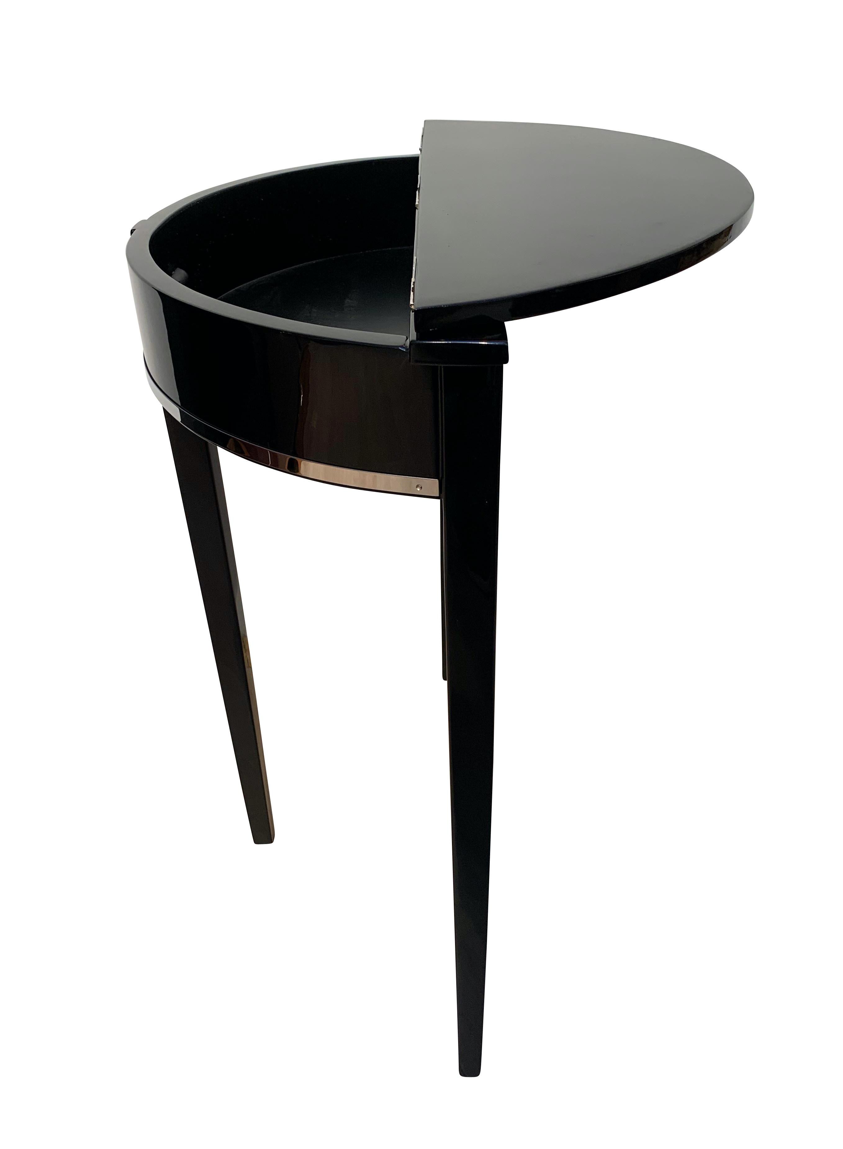 Art Deco demilune console table, black piano lacquer on oak, France, circa 1930

Oak solid wood, high-gloss black piano lacquered. Nickel-plated decorative trims. Newly galvanized old hinges.
Inside and underneath in satin black lacquer.