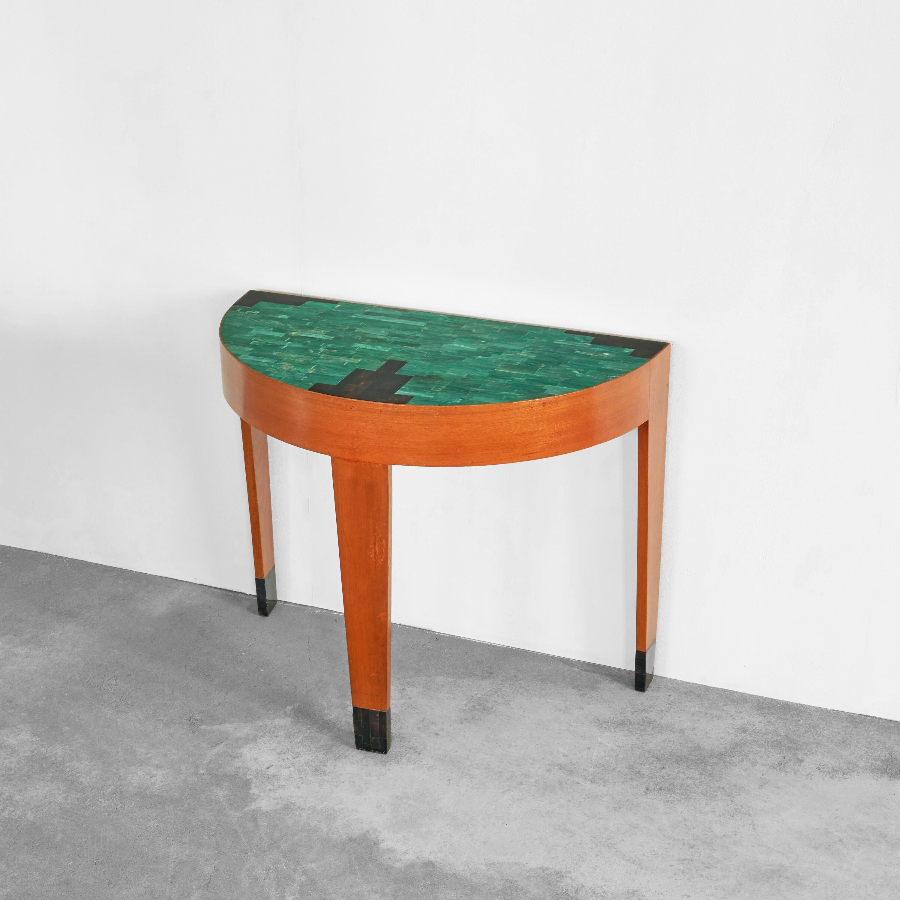 Art Deco Demi Lune Table in Malachite and Brown Shell Mosaic and Wood 1930s.

Exceptional demi lune console table, well crafted in teak with a top inlayed with green malachite and brown shell. This incredible piece shows a timeless design in the