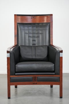 Art Deco design armchair with black leather with decorative stitching