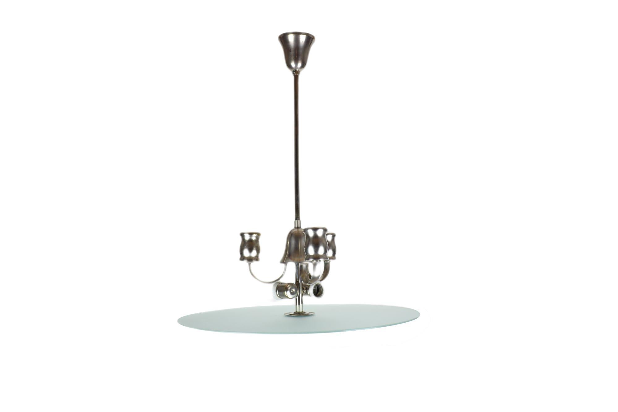 High-quality Art Deco luminaire which, thanks to its unique workmanship and design, perfectly decorates any interior. If you give room to your imagination, you may be struck by a sandblasted circular shade like a display case, behind which hides a