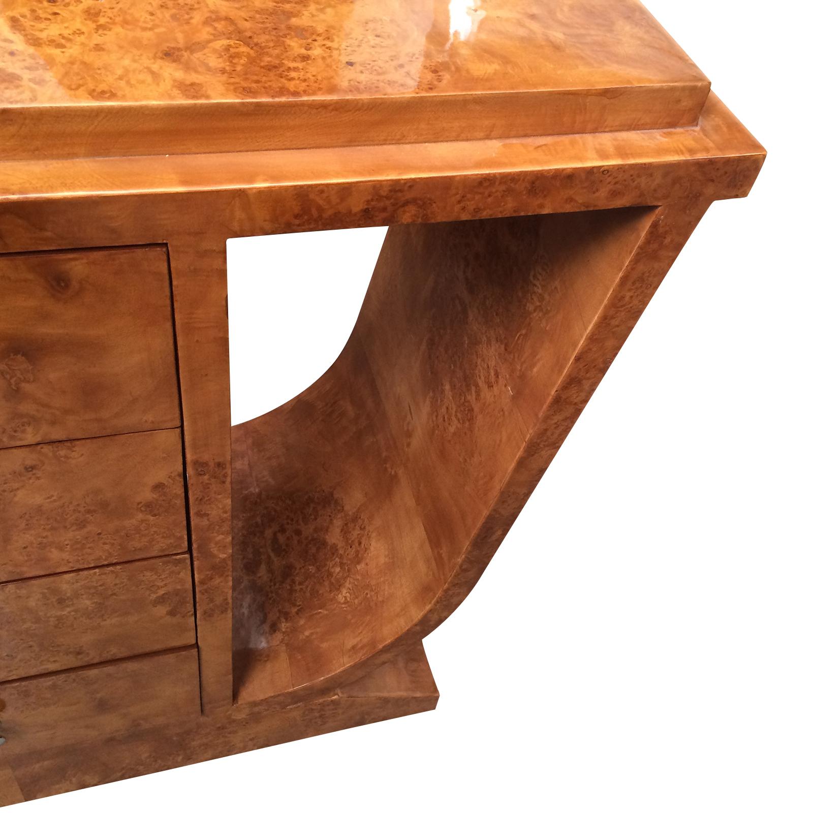 Art Deco design console table in burl Amboyna wood with 4 drawers to a central column in rectangular form. The top has also a large stepped edge to the front and the 2 sides. The 4 drawers, each with a central, mushroom shaped nickel handle. The