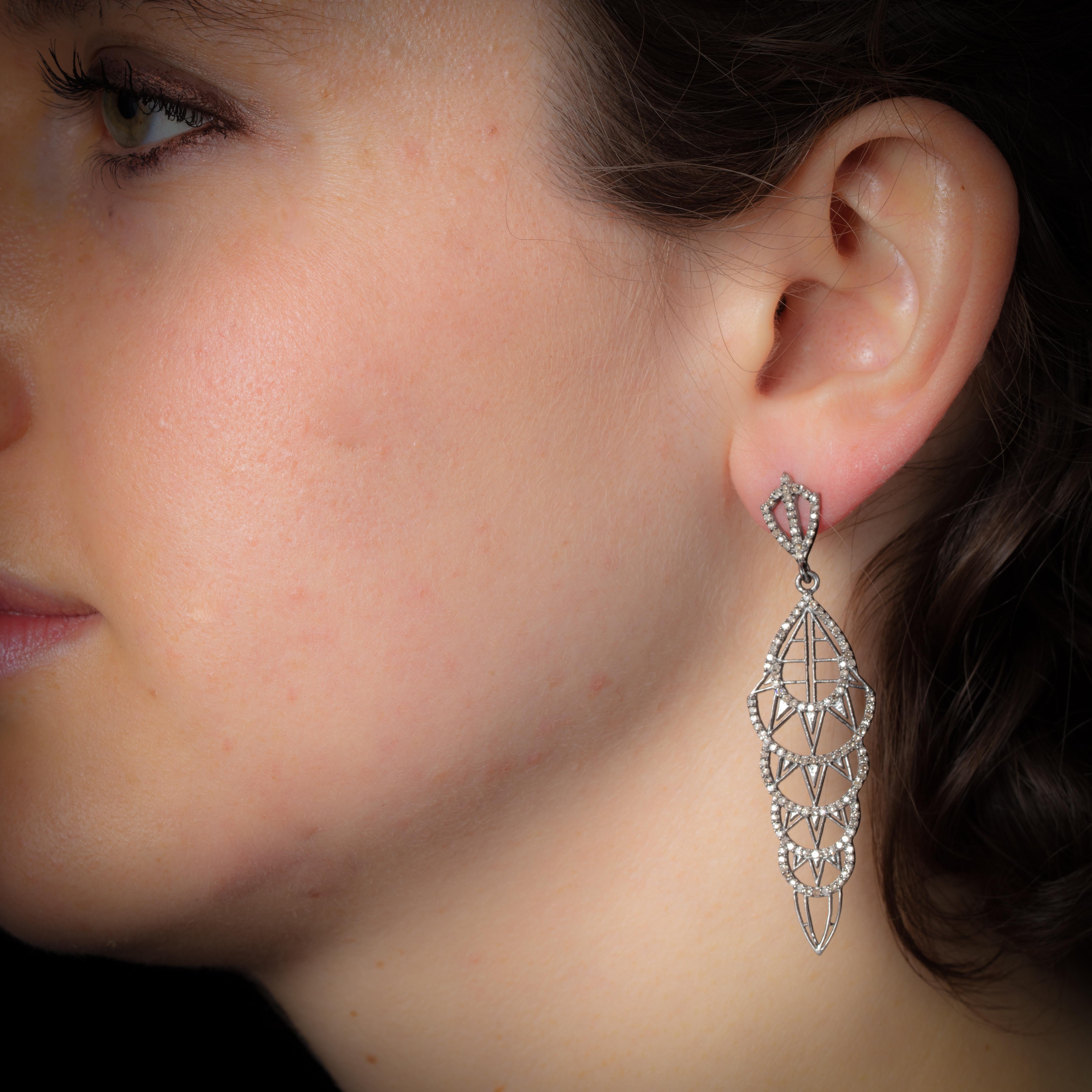 Very Frank Lloyd Wright, these Art Deco-inspired diamond dangle earrings.  With an architectural motif, the brilliant-cut, pave`-set diamonds are set in sterling silver with an 18K gold post for pierced ears.  Weight of diamonds is 1.54 carats.
