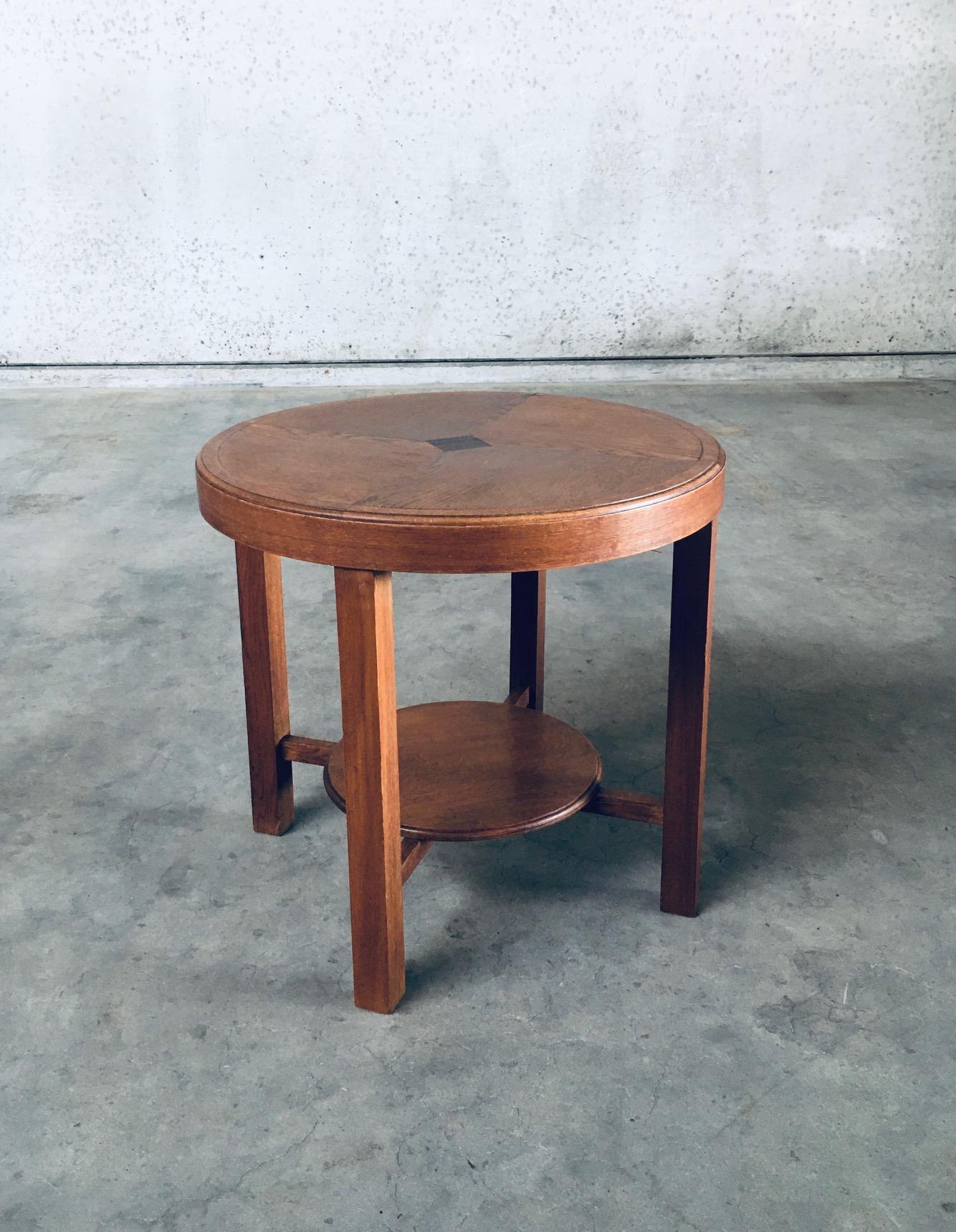 Vintage Art Deco Design Round Side Table. Made in Belgium, 1930's period. Solid oak constructed with veneer inlay on the top. This comes in very good, all original condition with normal wear from it's age and use. Measures 65cm x 70cm x 70cm.