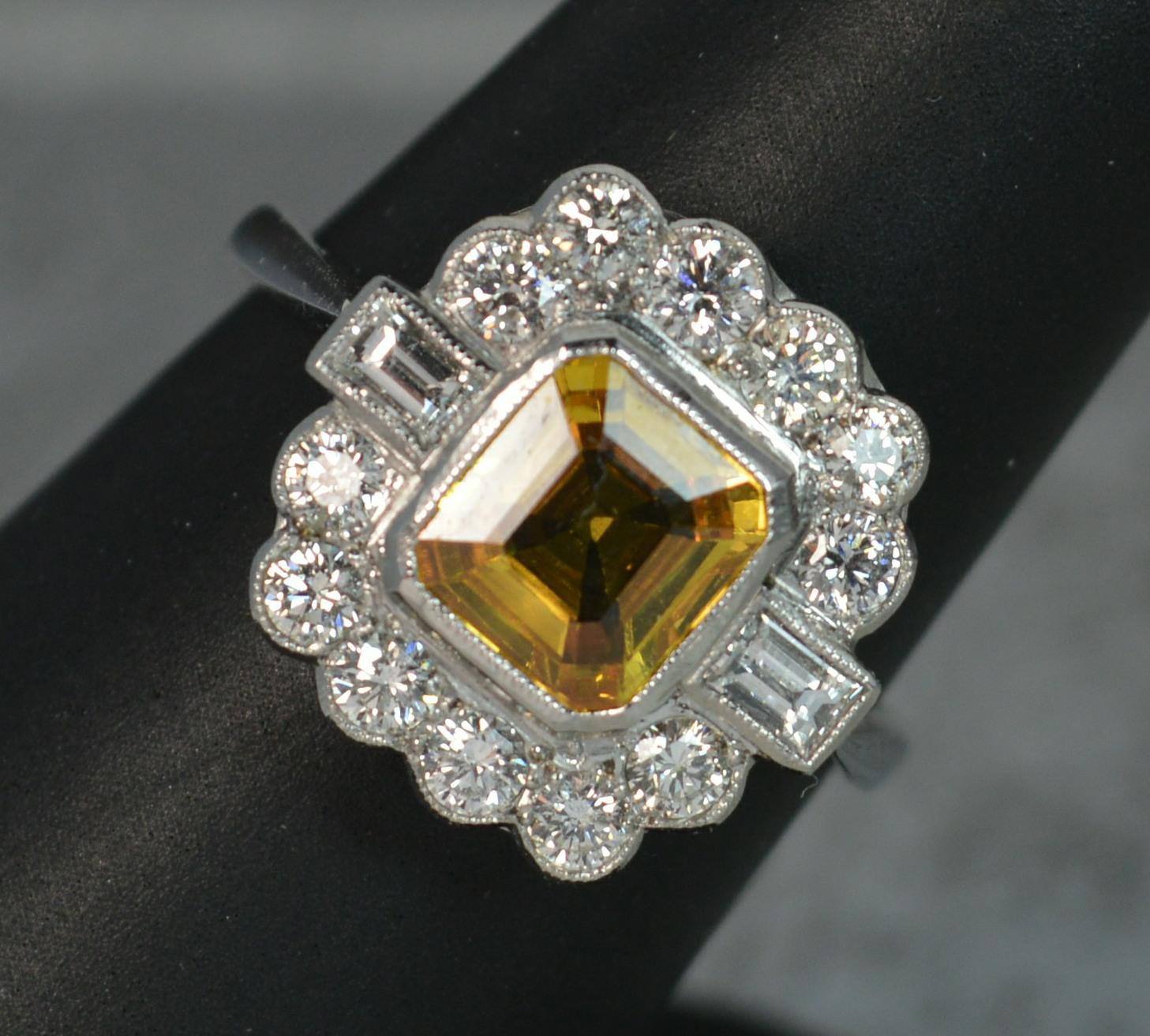 A stunning quality Yellow Sapphire and Diamond ring in Platinum.
​Designed with a cushion cut natural yellow sapphire to centre. Superb vivid colour. 6.6mm x 7.2mm, 1.2 carats. Surrounding are ten round brilliant cut diamonds and two baguette cut