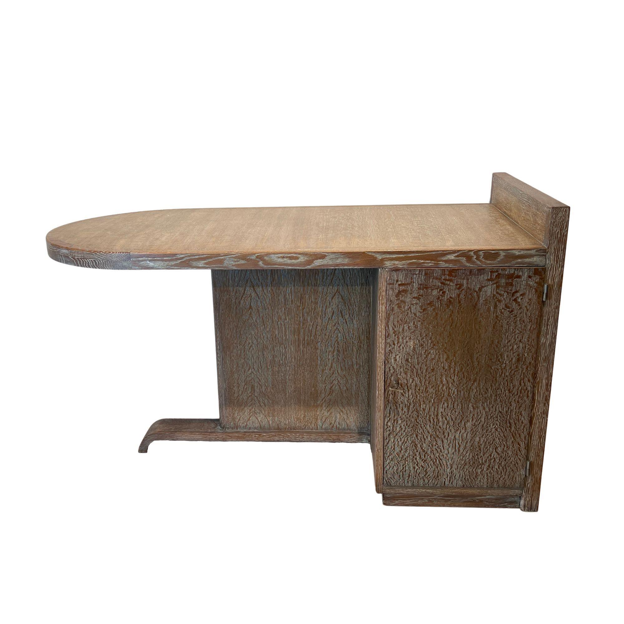Small modernist Art Deco Desk by De Coene Frères, Belgium circa 1930/40.
Elegant asymmetrical Art Deco design, Model “Depose”. Limed oak surface. Lockable doors on both sides. Inside there are drawers at the top, underneath an oak board. Stainless