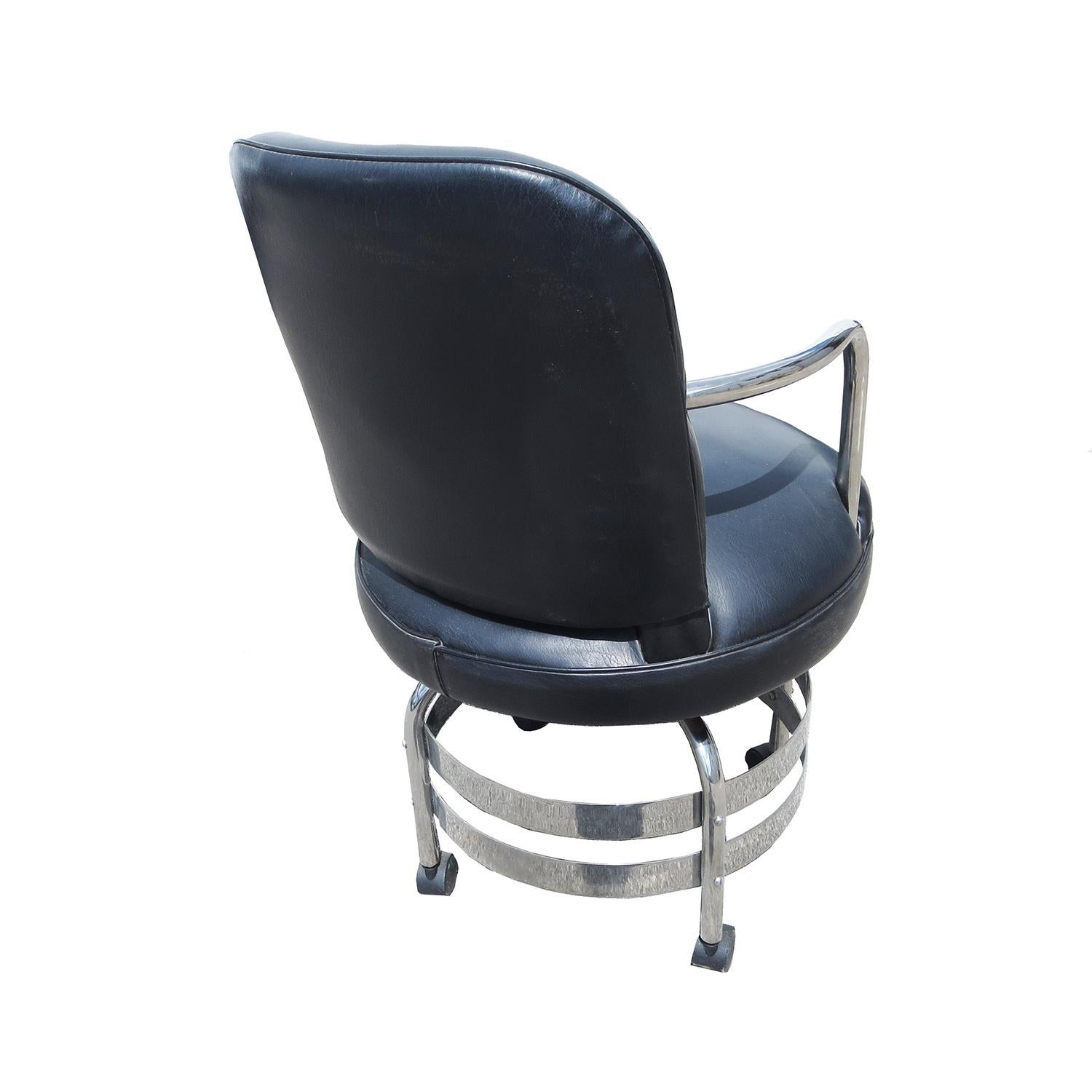 Put a little style into your workday with this fantastic Art Deco desk chair. The frame is a combination of tubular and flat banded chromed steel. The upholstery is black leatherette. The chair swivels, and will adjust in height by continued