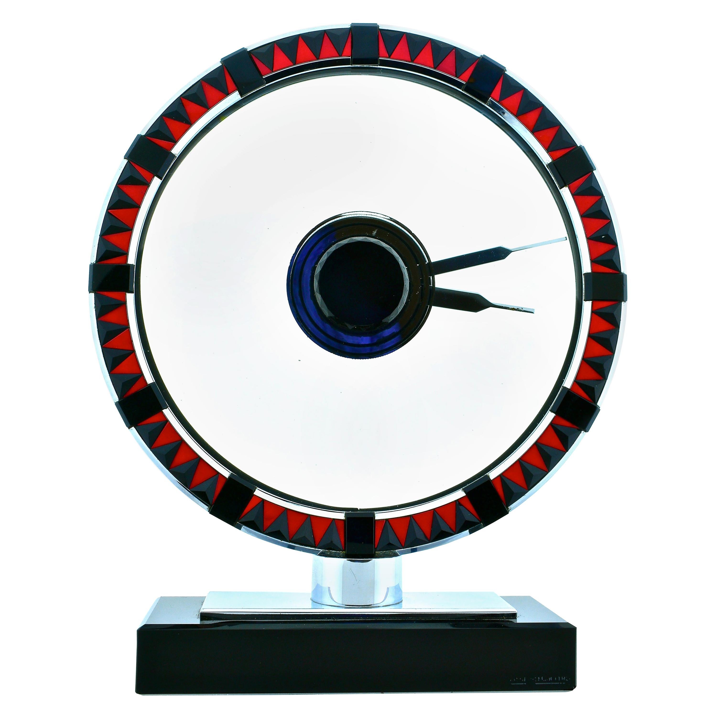 Jaeger LeCoultre Art Deco clock measuring 8 5/8th by 7 1/8th inches, this is likely a one and only example of an Art Deco clock in polished stainless steel, with faceted pyramidal triangular onyx alternating with vivid red (not orange), triangular