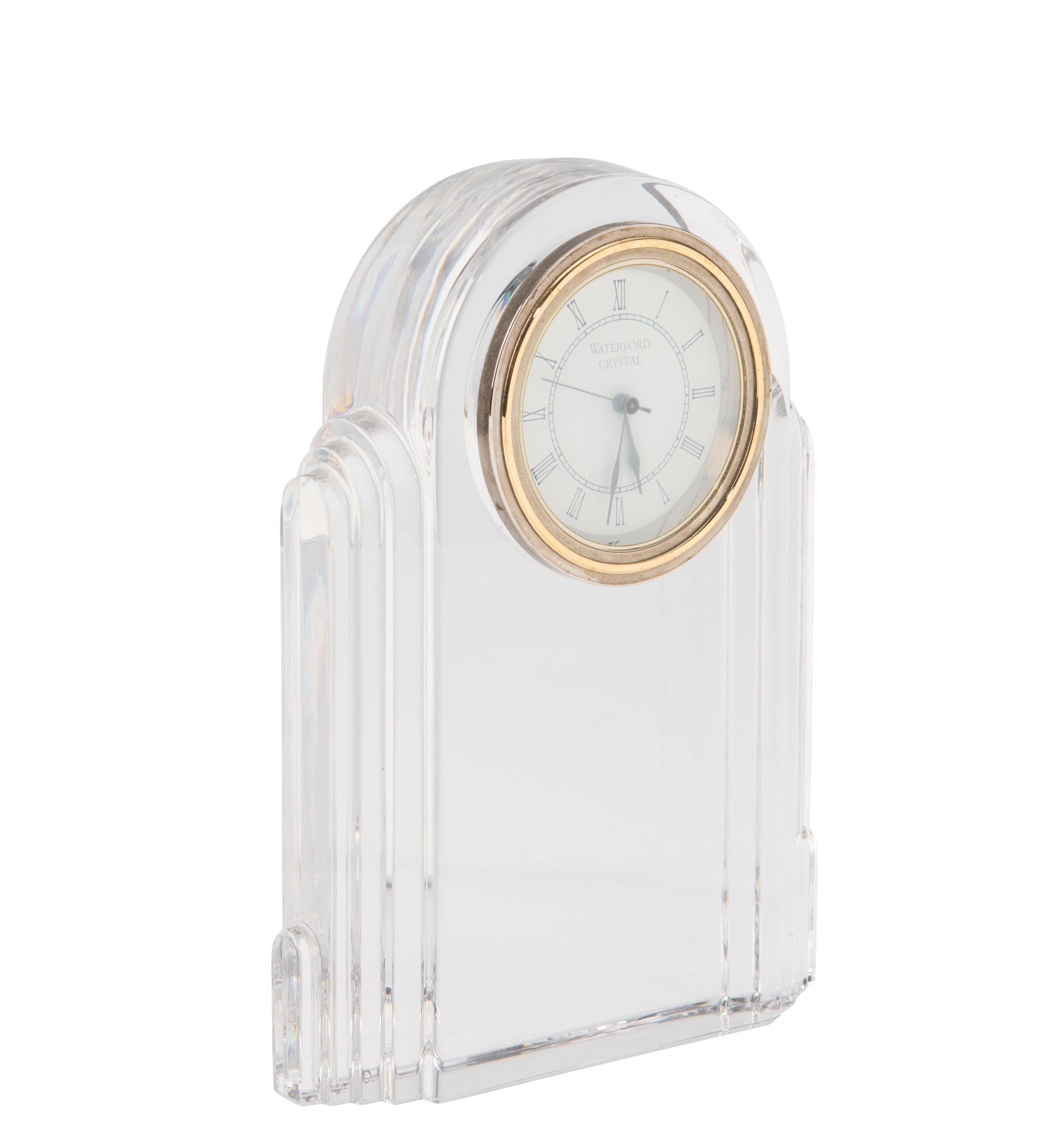 Classic deco desk clock in clear crystal by Waterford, 1999-2002. Desk clock has faceted sides and Roman numeral markers at clock centre.