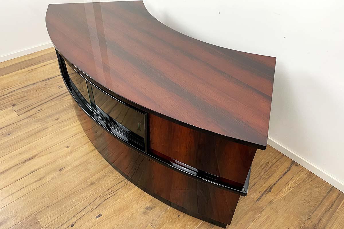 Impressive Art Deco desk in noble rosewood and black piano lacquer - all parts including glass and locks are original and in very good condition. The entire desk has been restored and polished by hand to a high gloss - a fantastic piece of history