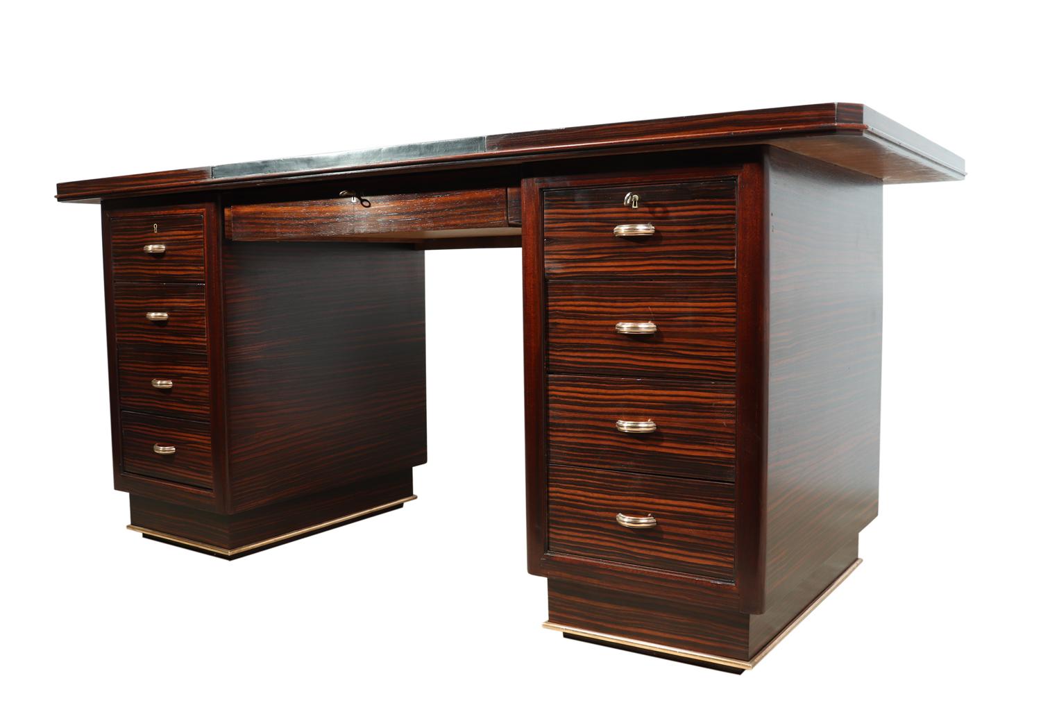 Art Deco desk in Macassar ebony, circa 1930

A good sized Art deco desk produced in Macassar ebony in France in the 1930s, it features 8 drawers brass hard wear and a leather inset top, the desk collapses into 4 pieces for ease of delivery, this