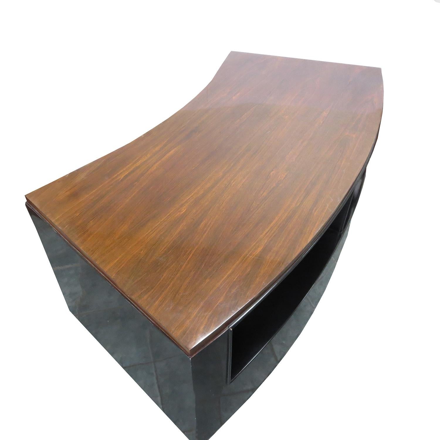 This lovely desk has served us well, but now must be part of our clearance sale! The top surface and drawer faces are a dark walnut, and the body is black lacquered. The desk has a pleasing curved shape, making it wider in the front, and narrower in