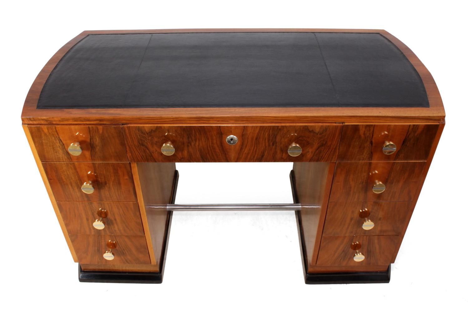 Art Deco desk in walnut, French, circa 1930.
This Art Deco desk has nine drawers, domed ends, new leather top, brass and chrome handles, the desk has been fully restored and hand polished and is in very good condition through out.

Age: