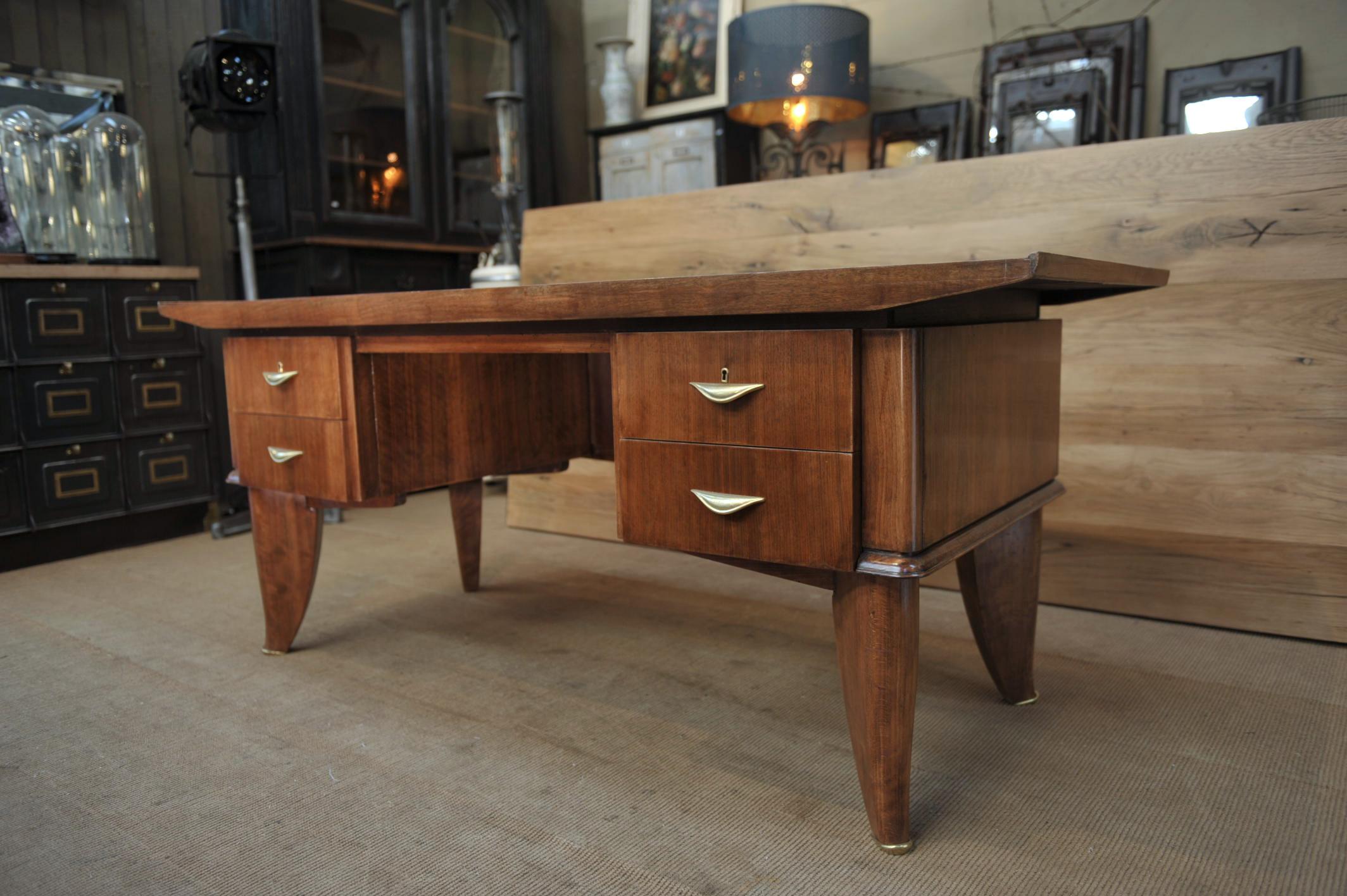Art Deco 4 drawer desk by  Sanyas & Popot, France in walnut wood and bass handles and feet excellent condition, circa 1930.