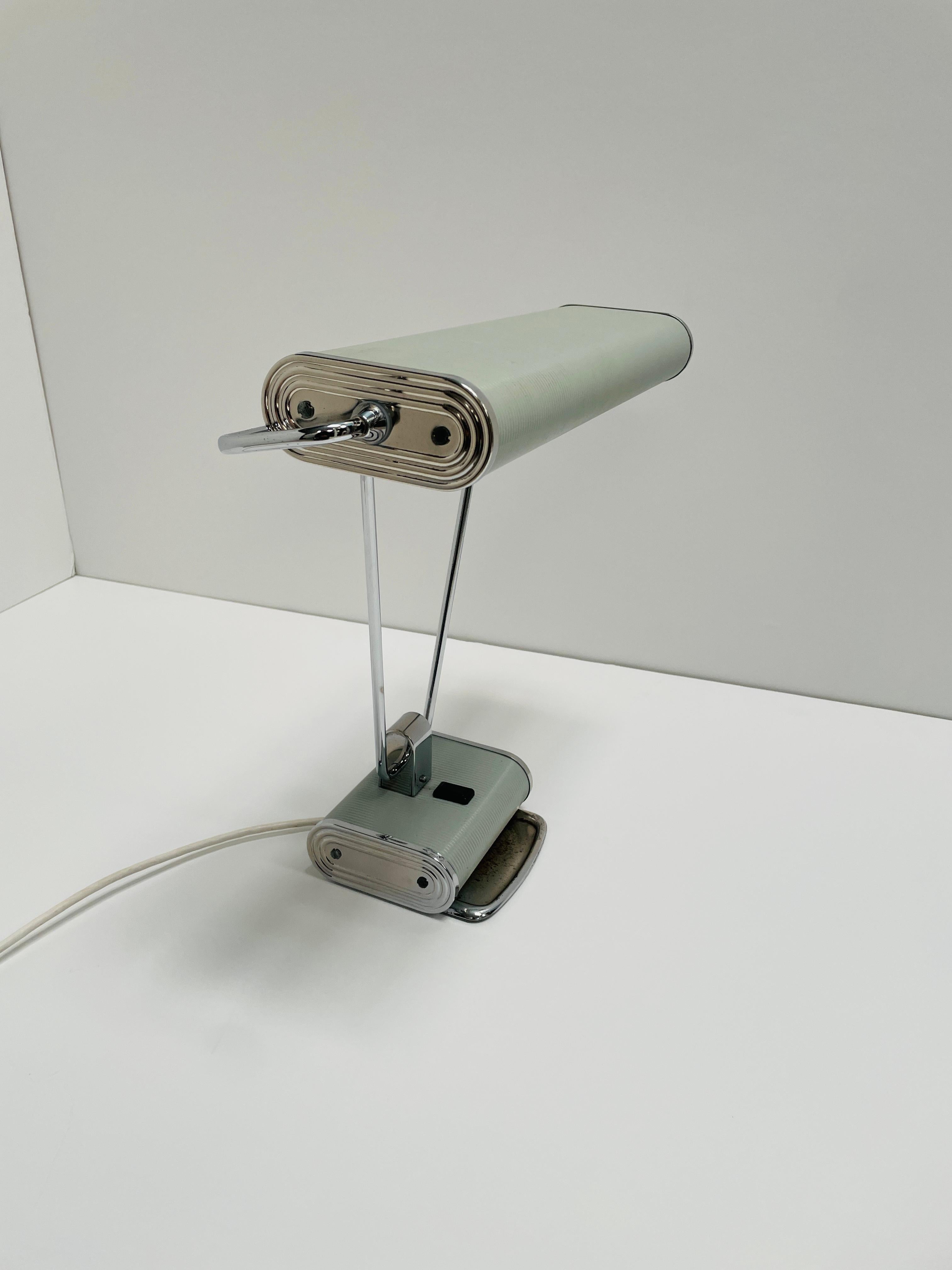 This iconic desk lamp has its original pastel blue finish. We have rewired and refurbished the lamp with US sockets and new wiring. The lamp offers a versatile lighting source since the head of the lamp can be oriented to direct the light as needed.