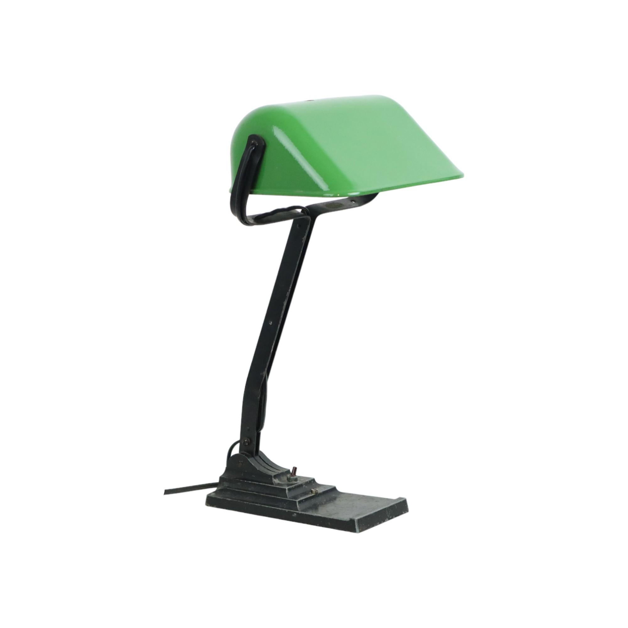 Iconic art deco desk lamp, also called notary lamp or banker's lamp, made by the Belgian company Erpé, model no. 52, industrial design from the 1920s-30s.

This beautiful lamp is made of a metal stepped base, a wrought iron neck and a green