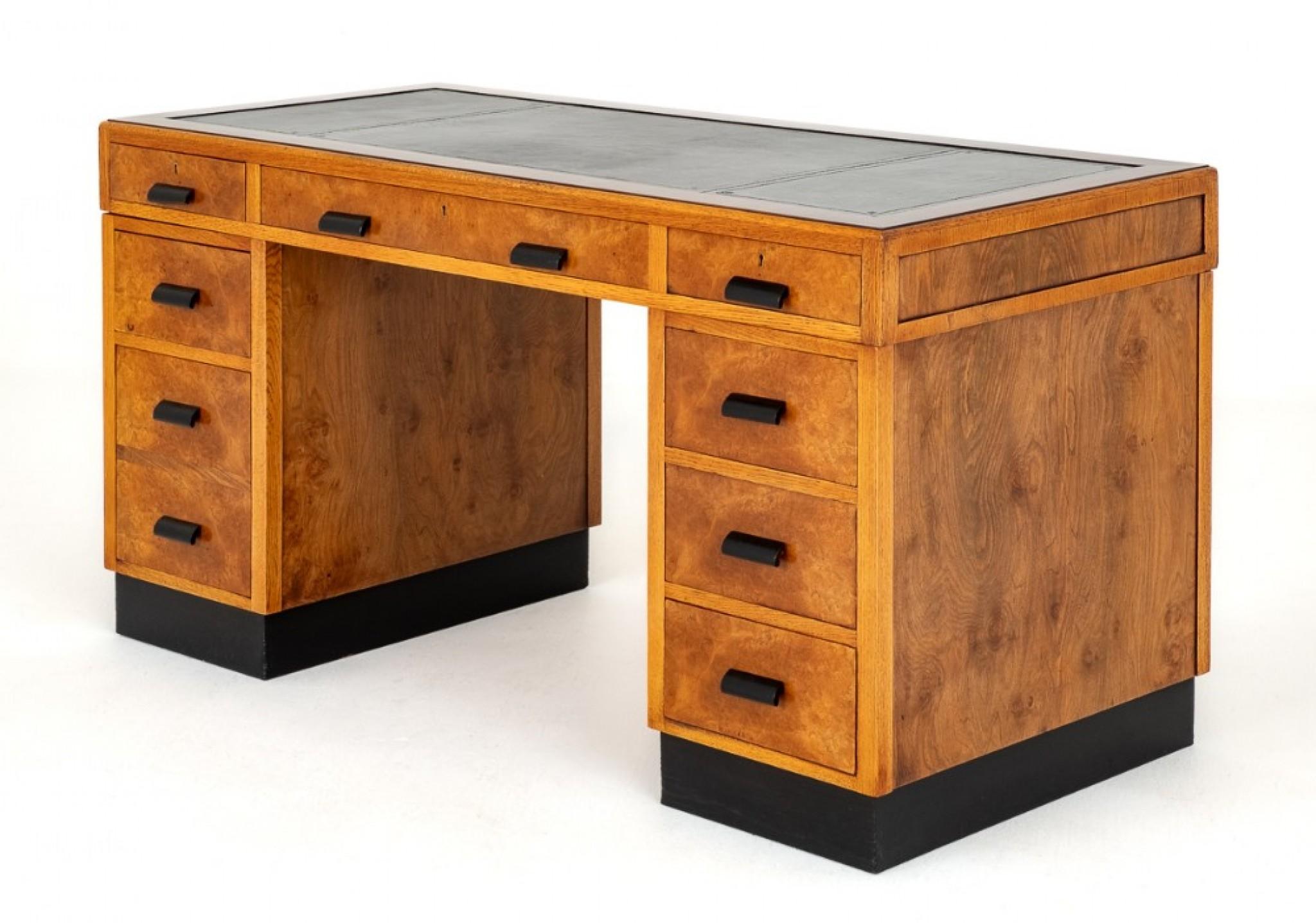 Art Deco Walnut Desk.
This Wonderful 9 Drawer Desk Stands upon a Typical Art Deco Ebonised Plinth.
The Desk Having 9 Mahogany Lined Working Drawers With Ebonised Handles.
The Desk is Veneered in a Quality Burr Walnut.
The Top of the Desk Features