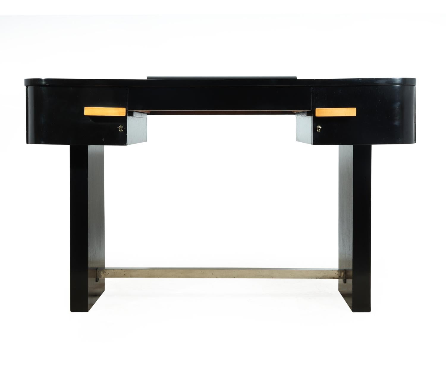 Art Deco desk piano lacquer black finish with leather inset top
This small Art Deco period writing table has a central drawer and lockable cupboard doors either side, chromed brass footrest, and leather inset top, the desk has been fully restored