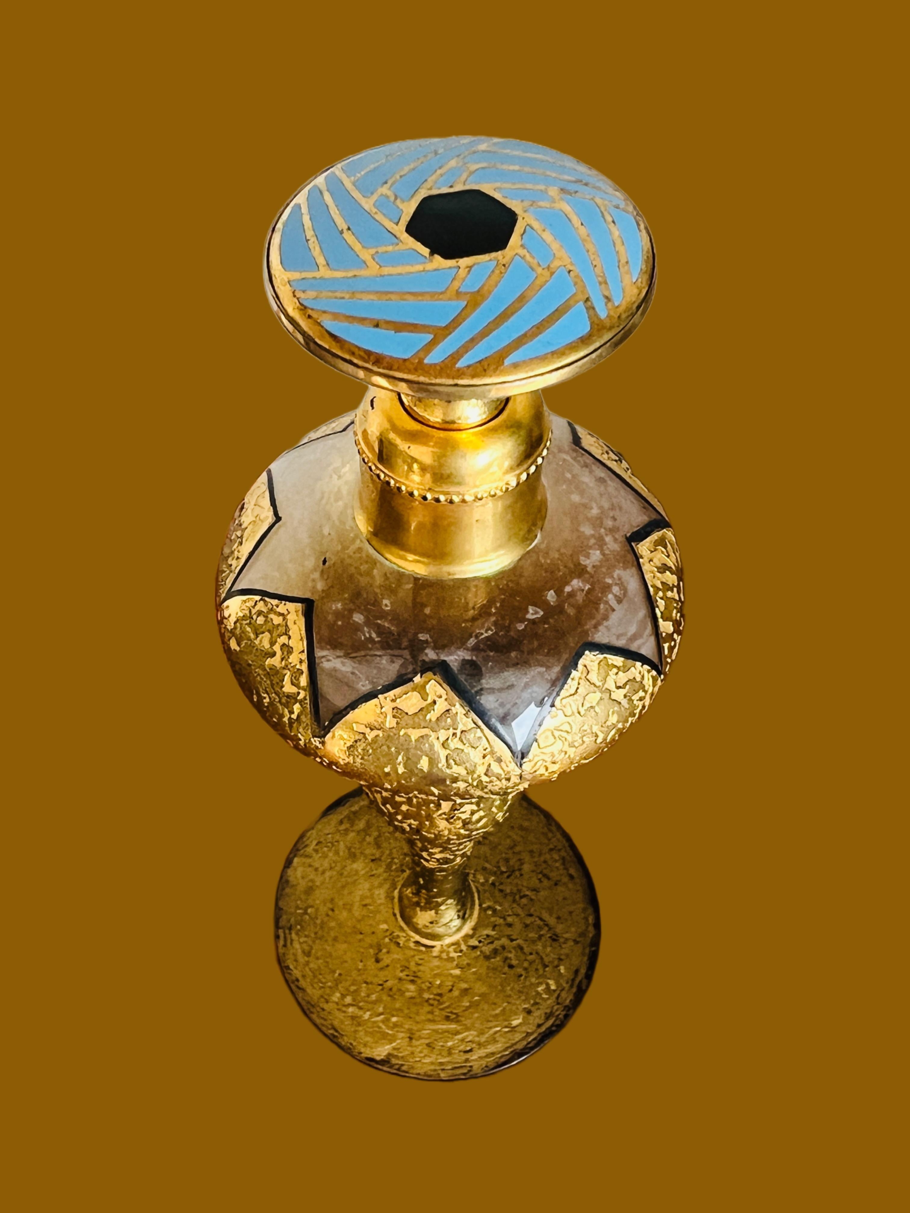 Very elegant DeVilbiss blue and black enamel gold encrusted perfume bottle from the roaring 20's. 

Size: 5-1/2