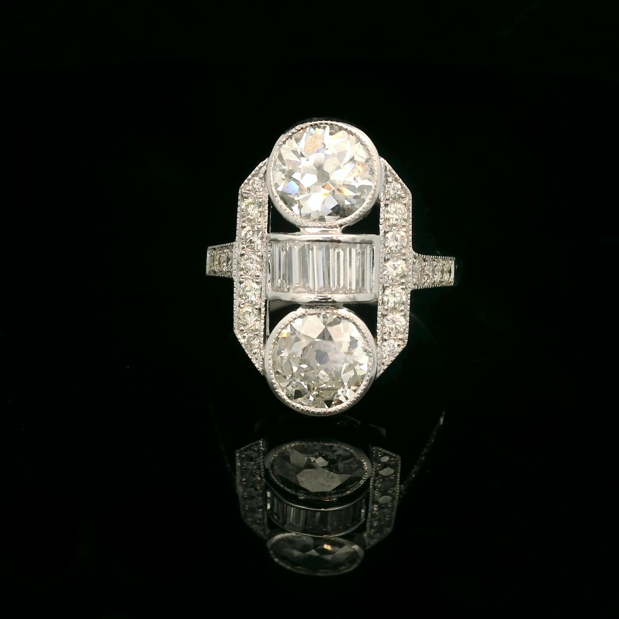 White gold 18 Karat ring. 

The ring is set with two main old European cut diamonds: one diamond of 1.02 Carats (I/J color - Vs clarity) and one diamond of 1.08 Carats (Si clarity - J/K color). 

The ring is also set with 22 brilliant cut diamonds