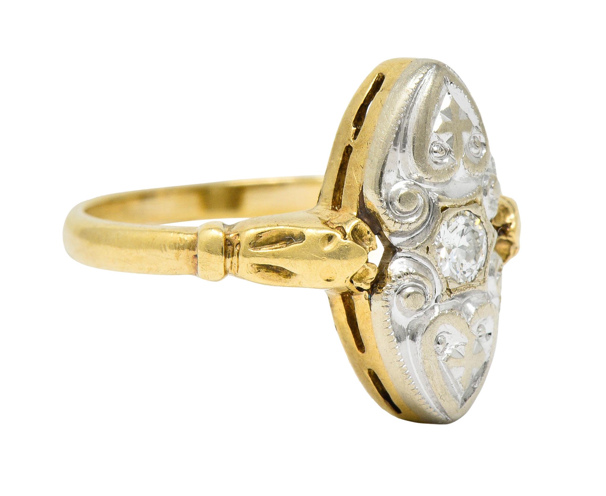 Navette shaped dinner ring with stylized shoulders and heart motif scrollwork

Centering a round brilliant cut diamond weighing approximately 0.10 carat; eye-clean and white

With maker's mark and stamped 14K for 14 karat gold

Circa: 1930s

Ring