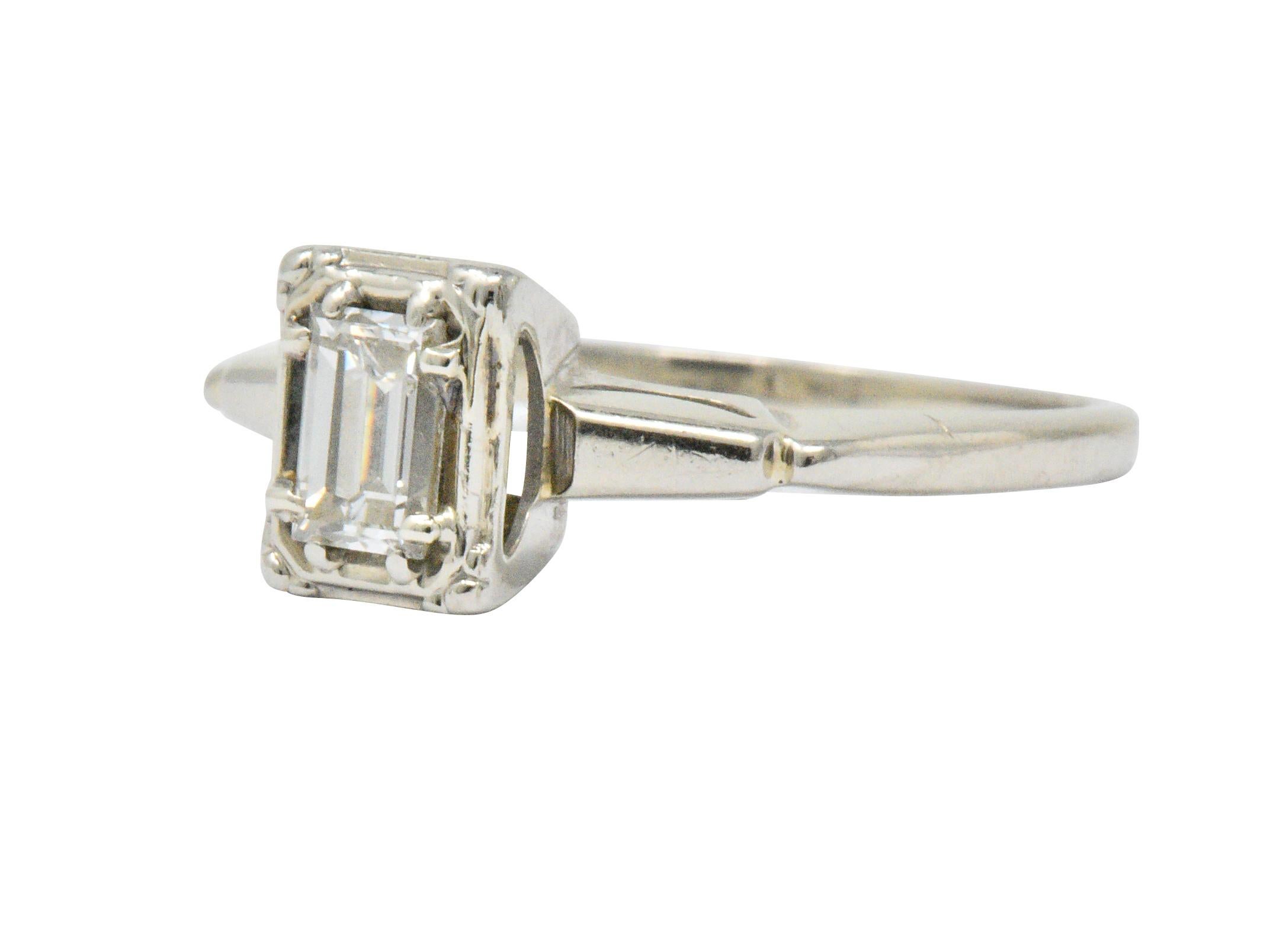 Centering an emerald cut diamond weighing approximately 0.35 carats, G color and VS clarity

In an illusion mount with highly polished tapered shoulders

Stamped P-K

Ring Size: 5 & Sizable

Top measures 7.1 mm and sits 5.6 mm high

Total Weight:
