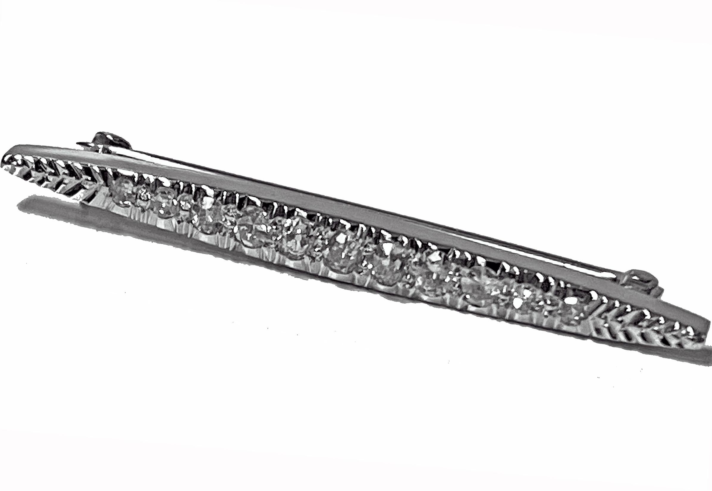 Art Deco Diamond 14K white gold Brooch, C.1920. The elongated tapered brooch set with 11 mixed old cut diamonds, total diamond weight approximately 0.12 ct, average SI clarity, average I colour. Bar pin with safety catch. Length: 37.00mm. Maximum