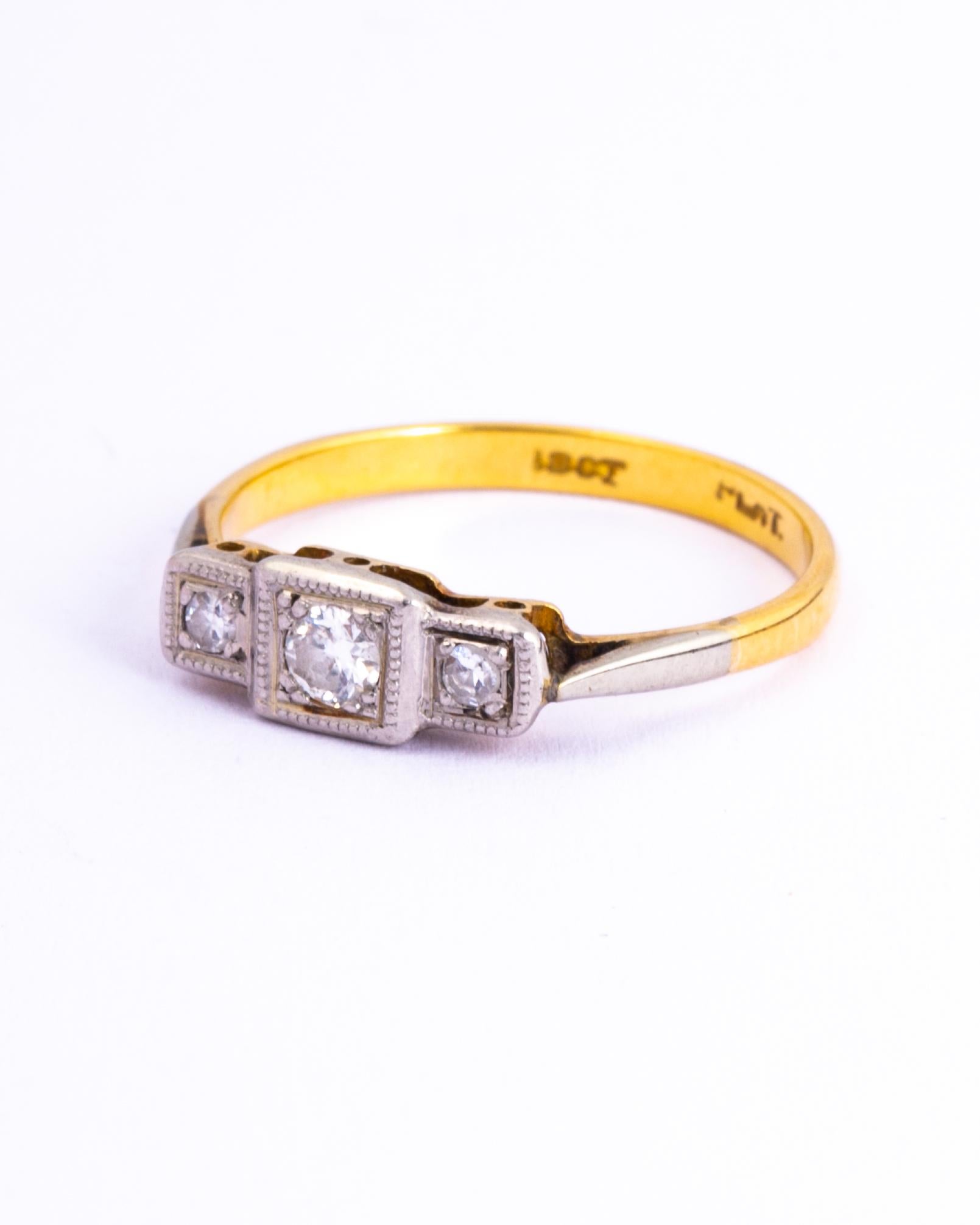 In classic Art Deco style this three stone diamond ring is made up of squares and panels of platinum. The diamonds total approx 20pts and are set upon an open work gallery.

Ring Size: M or 6 1/4 
Band Width: 5mm
Height Off Finger: 2mm

Weight: 2.1g
