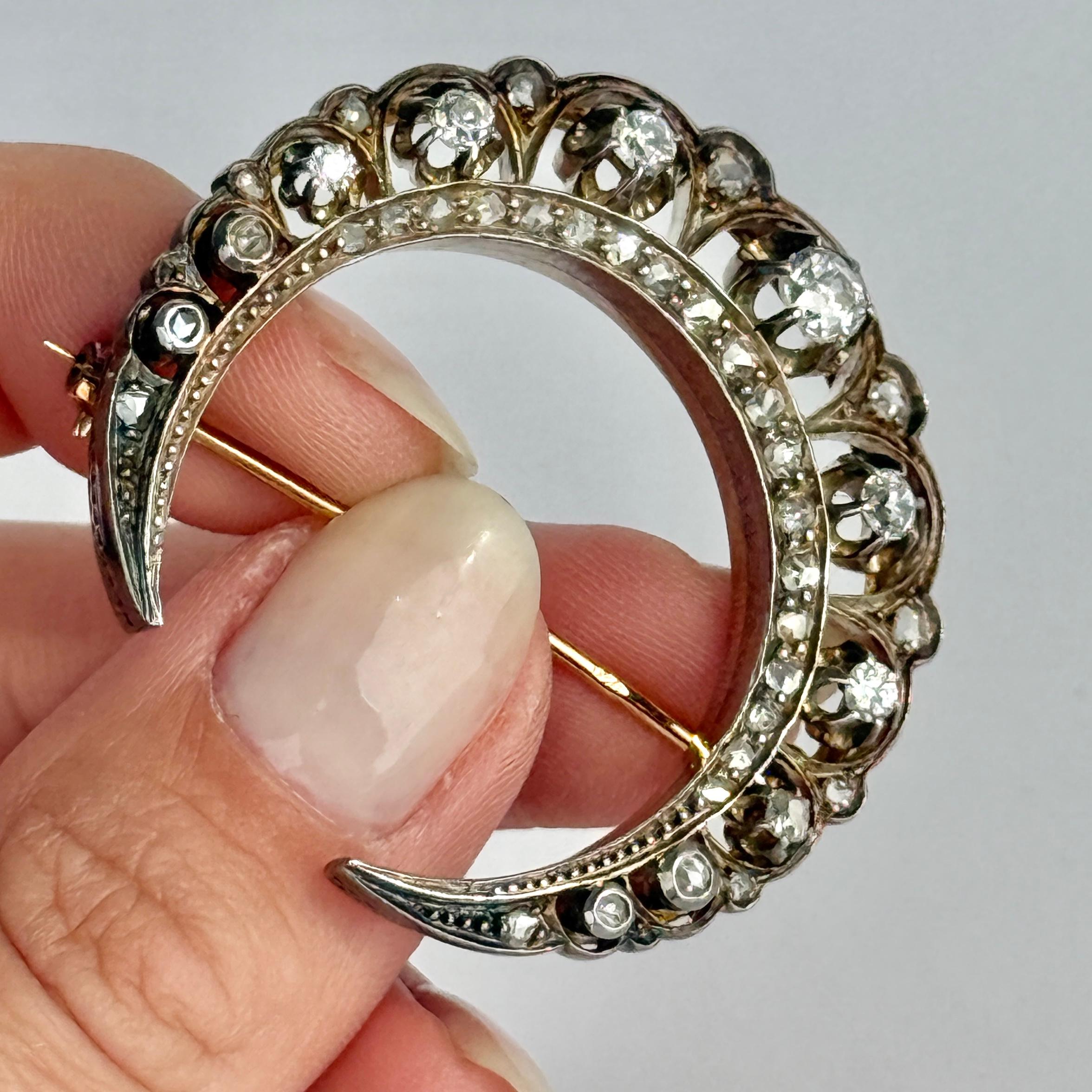 This gorgeous crescent is modelled in 9 carat gold. The larger diamonds are old mine cut and the rest of them are rose cut. The total diamond weight of this brooch is 1.36carat. 

Dimensions: 44x42mm

Weight: 16.8g