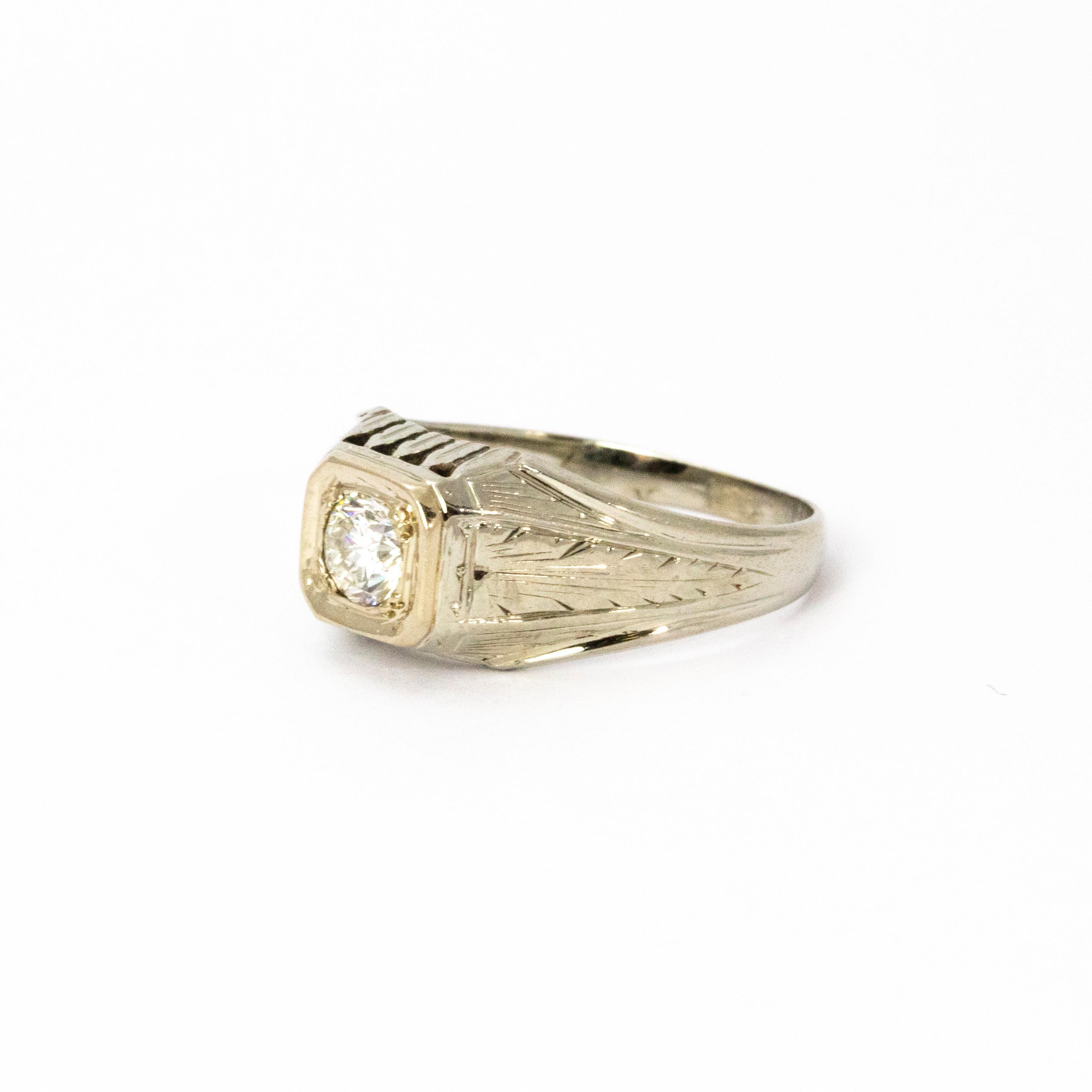 A stylish Art Deco diamond ring modelled in 18 karat white gold with square setting and pretty hand engraved shoulders. The beautiful old European cut diamond measures approximately 50 points, colour VS2.

Ring Size: P 1/2 or 8