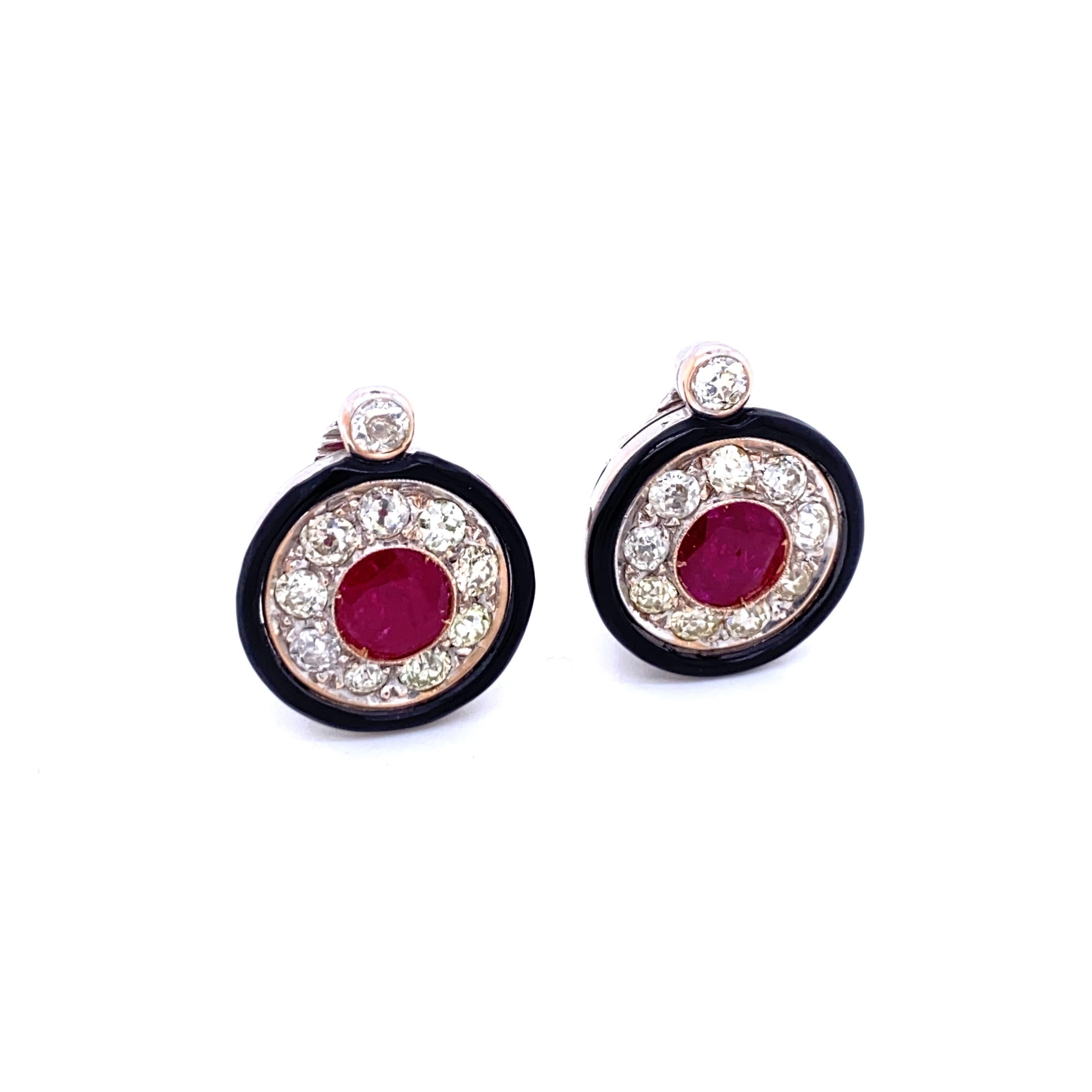 Unusual 18k gold Cluster earrings authentic from 1930.
The Earrings are set with 2.50 carats of Sparkling Old mine cut Diamonds graded H/I Color Vs clarity and in the center with  two Natural Ruby weighing 1.00 carat each, framed in an onyx