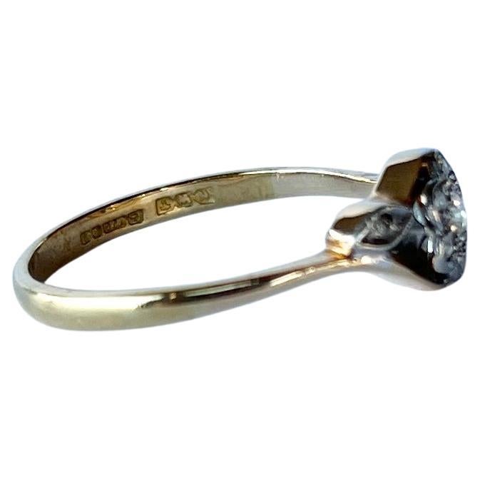 Classic sparkling diamond cluster ring with delicate diamond leaf shoulders all set in platinum on an 18ct gold band. Diamond total approx 29pts. Fully hallmarked Birmingham 1917.

Ring Size: P or 7 1/2
Cluster diameter: 7mm

Weight: 2.4g