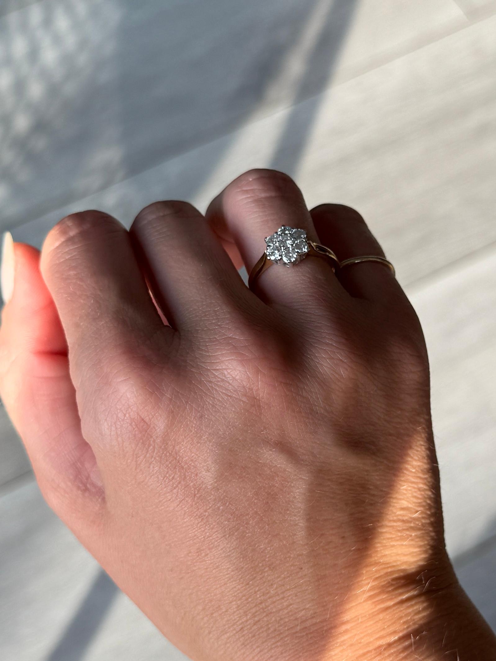 Ein Cluster-Set mit einem zentralen Diamanten von 10pts und die Diamanten insgesamt ca. 70pts. Der Ring ist aus 18 Karat Gelbgold modelliert und die Steine sind in Platin gefasst. 

Ring Größe: M 1/2 oder 6 1/2 
Cluster-Durchmesser: 10mm
Höhe ab
