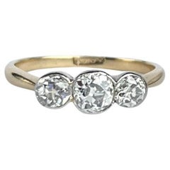 Diamante Art Déco e tre pietre in oro 18 carati