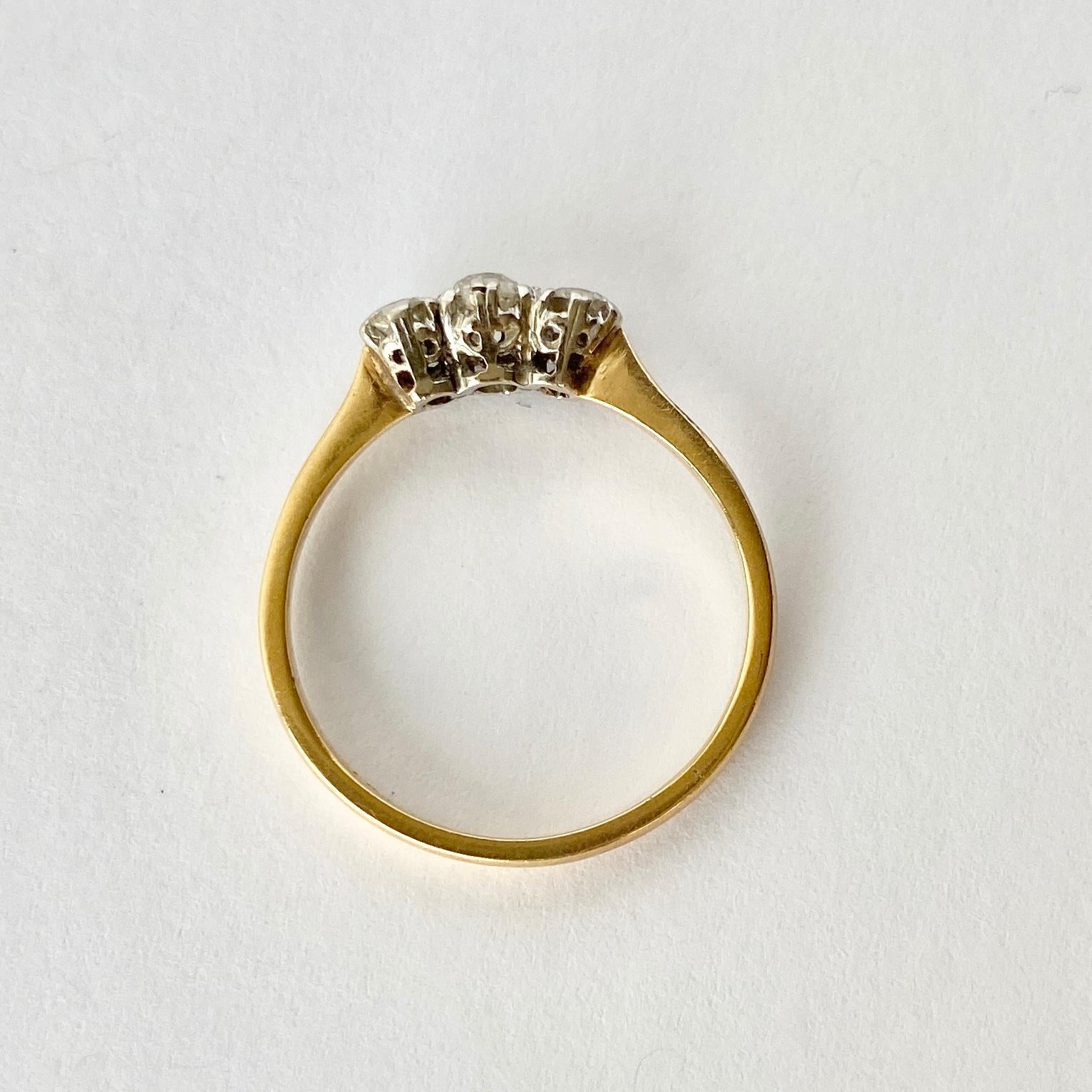 The diamonds in this ring total 55pts and old European cut and are bright and sparkly. They are held in very subtle platinum claws upon an 18carat gold band. 

Ring Size: Q or 8 

Weight: 2.6g