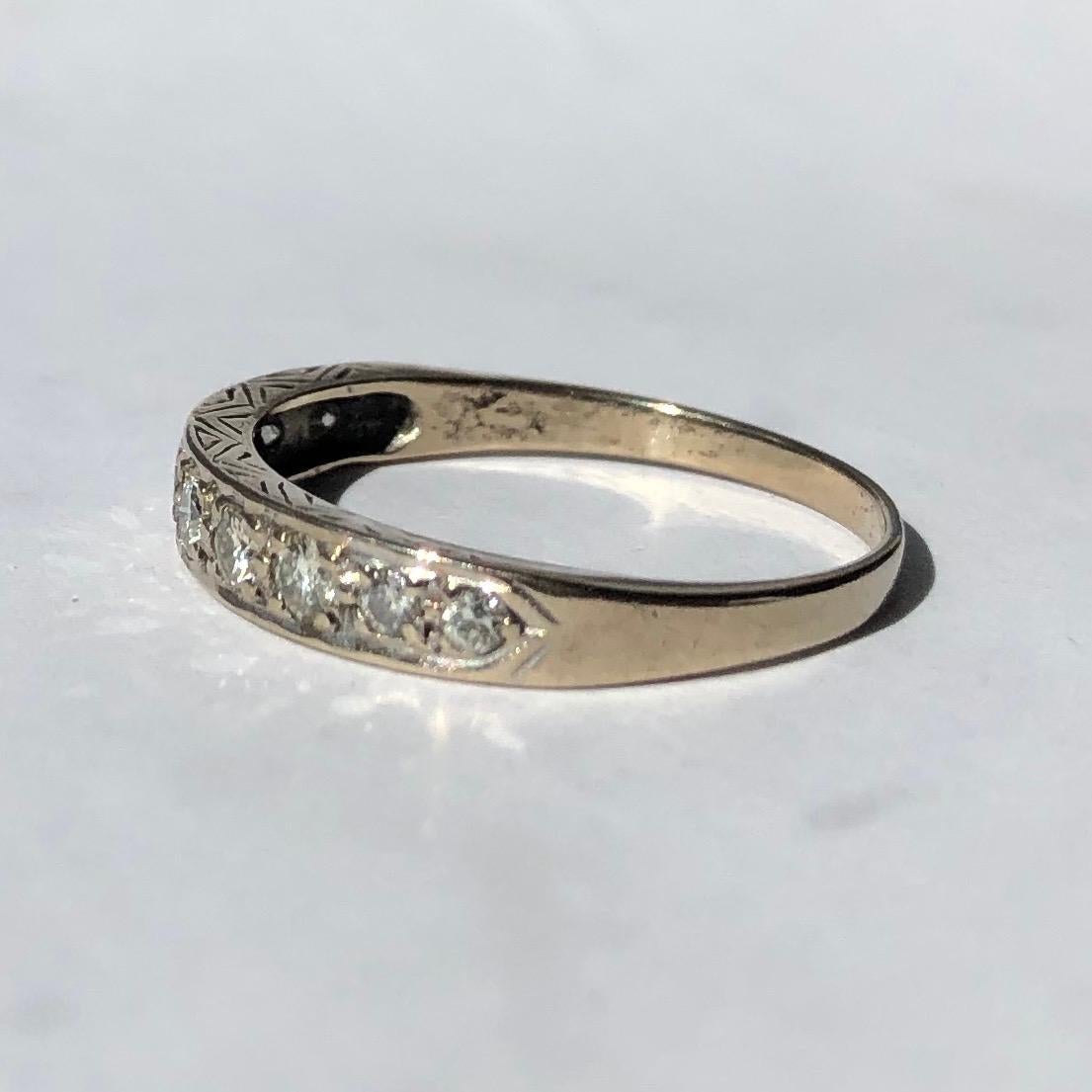 This half eternity band holds 60points worth of shimmering old European cut diamonds. The side of the band has fine engraving on it and the stones are set flush within the white gold band. 

Ring Size: S or 9 1/4 
Band Width: 3.5mm 

Weight: 2.93g
