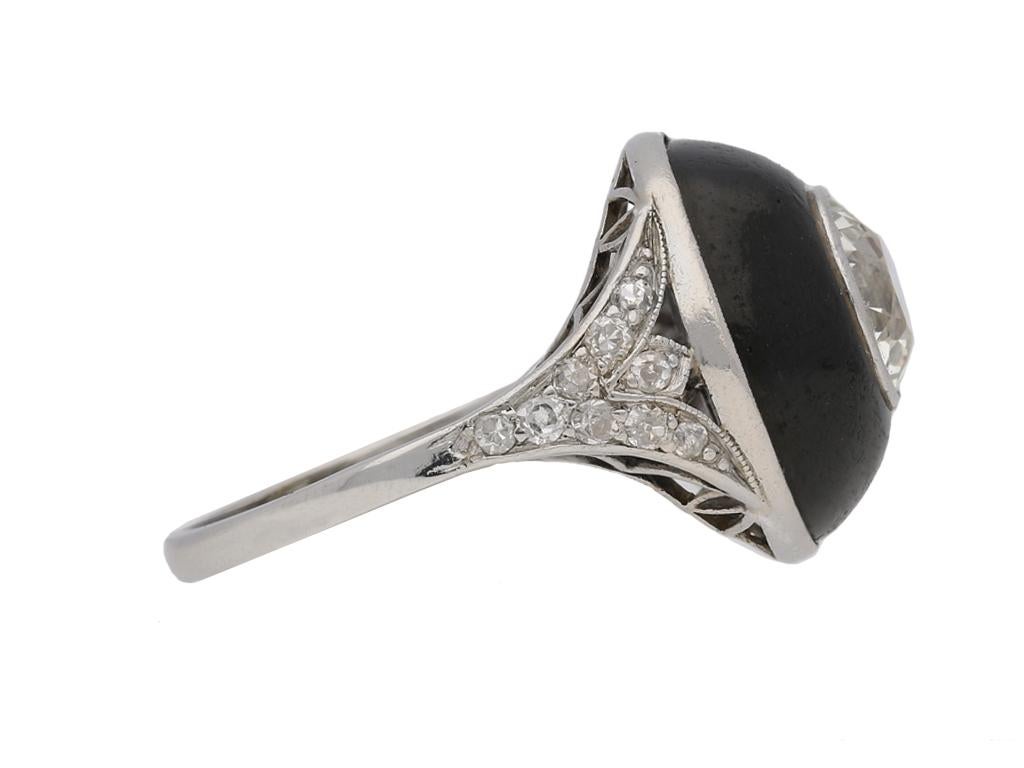 Art Deco diamond and black enamel ring. Set to centre with a round old cut diamond in an open back rubover setting with a weight of 2.00 carats, decorated throughout with eighteen round old cut diamonds in open back grain and millegrain settings