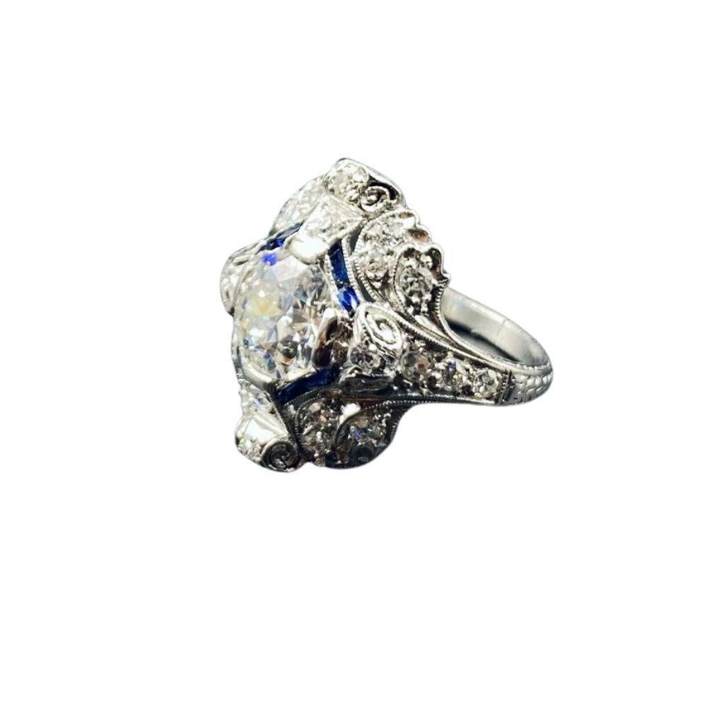 Art Deco era diamond and blue sapphire ring, featuring an old European cut diamond set in a platinum ring with a combination of blue sapphire and old mine diamonds.

Diamond Details
Shape	Old European Brilliant 
Color	H 
Clarity	I1
Weight