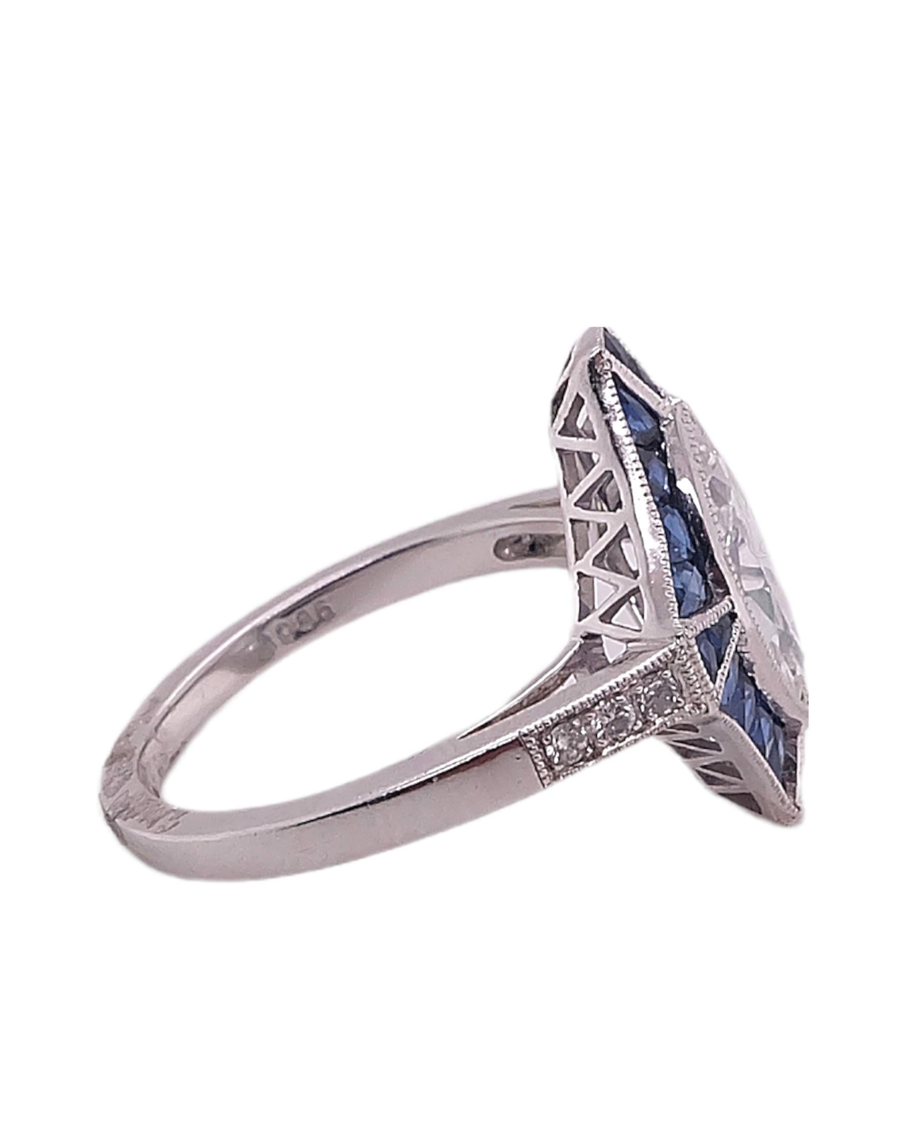 An Art Deco platinum ring with 1.22 Marquise Cut center stone complemented with 0.97 carats blue sapphires and 0.06 carats round diamonds made by Sophia D. Ring is available for resizing.

Sophia D by Joseph Dardashti LTD has been known worldwide