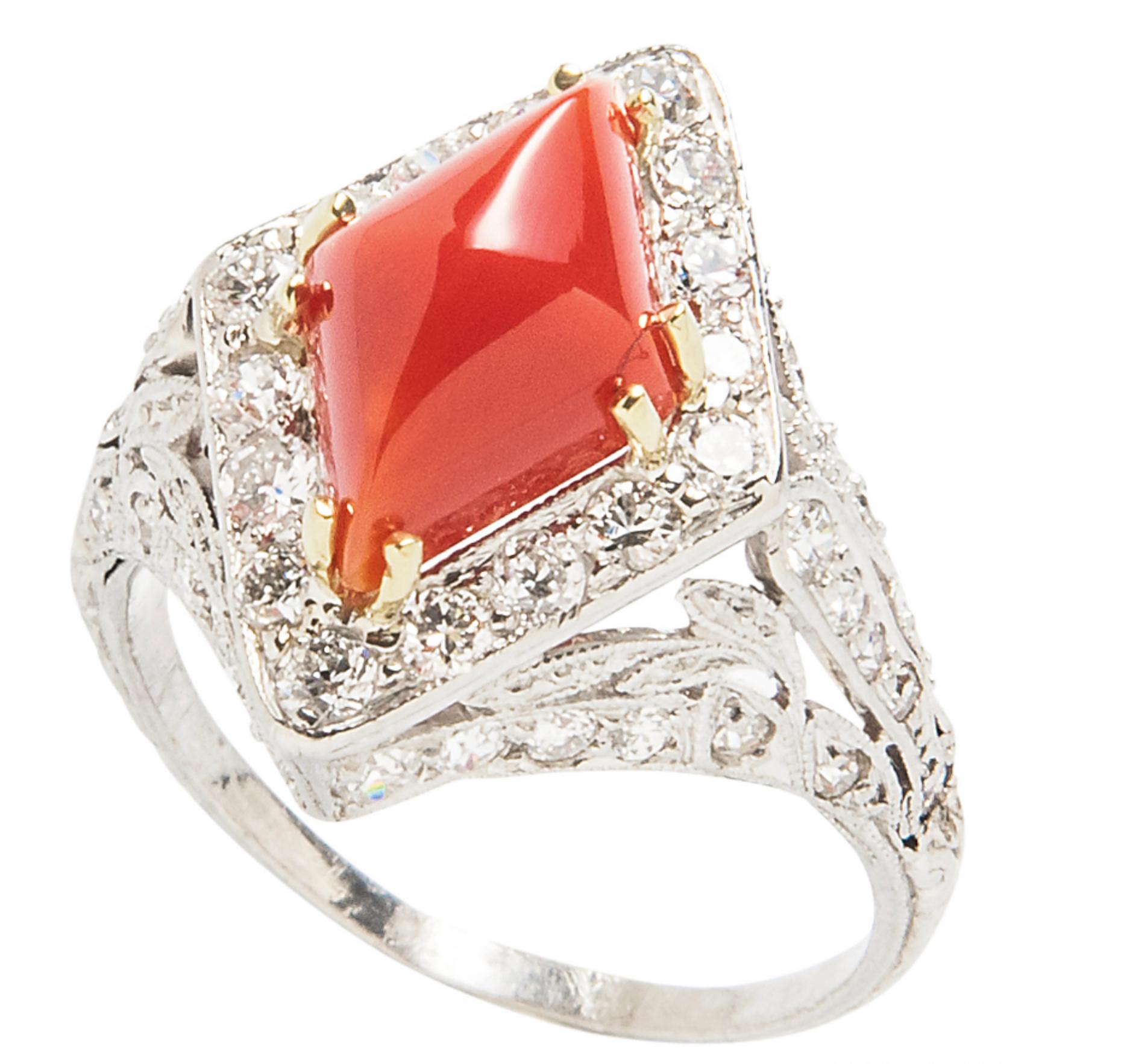 A platinum Art Deco ring featuring Oxblood Coral Navette Cabochon surrounded by Old European, Full Cut and Single Cut Diamonds approximately 1.25-1.50 carats.  Size 7.