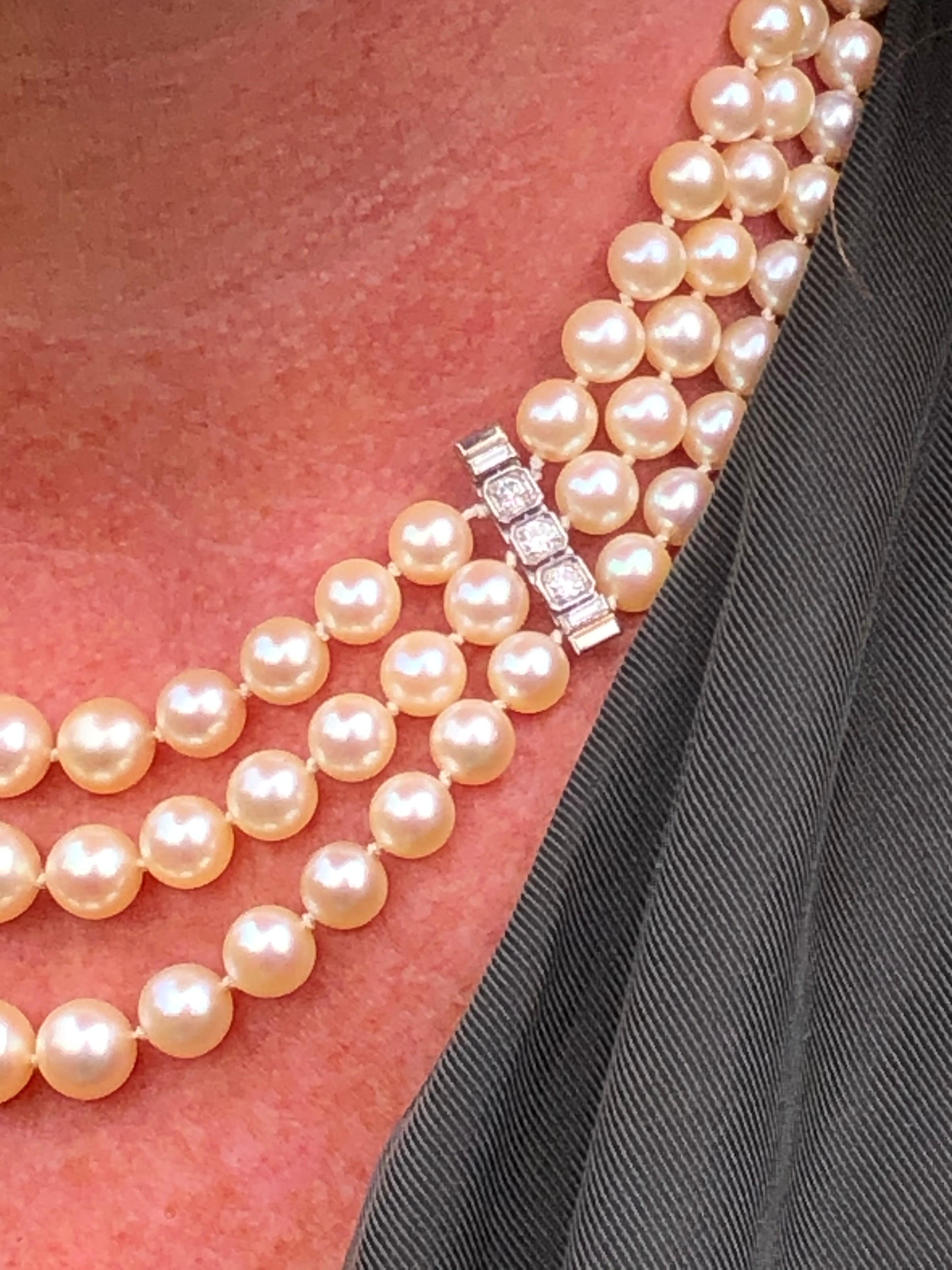This absolutely stunning and classic triple row pearl necklace has the most exquisite emerald cut diamond clasp, spacers and it also has a French eagle hallmark and are all 18ct gold. The diamonds total to approximately 2ct in the clasp and spacers